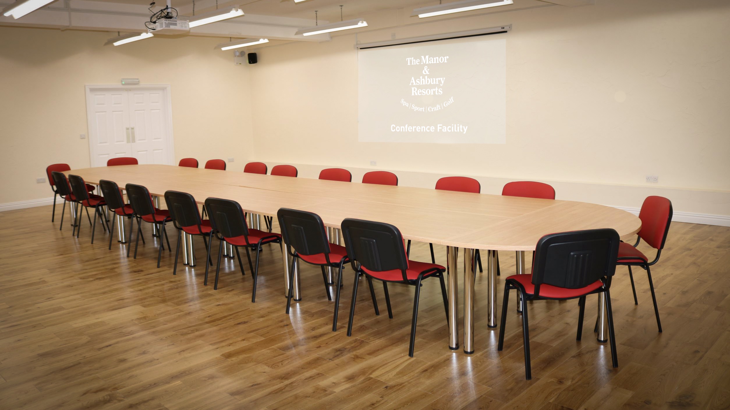 Spacious conference room with oval table, perfect for meetings and presentations.
