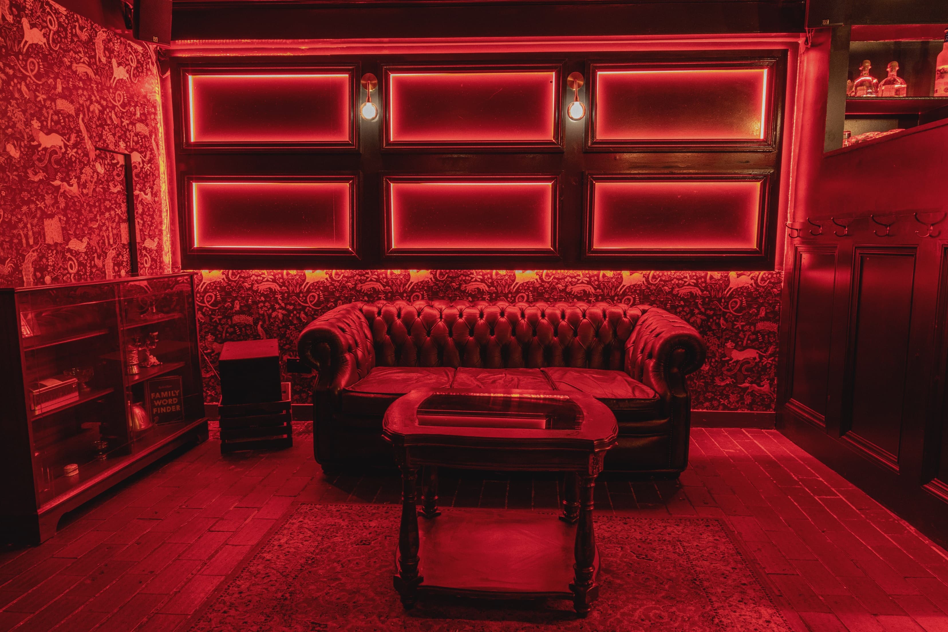 Stylish lounge with red lighting, ideal for networking events and gatherings.