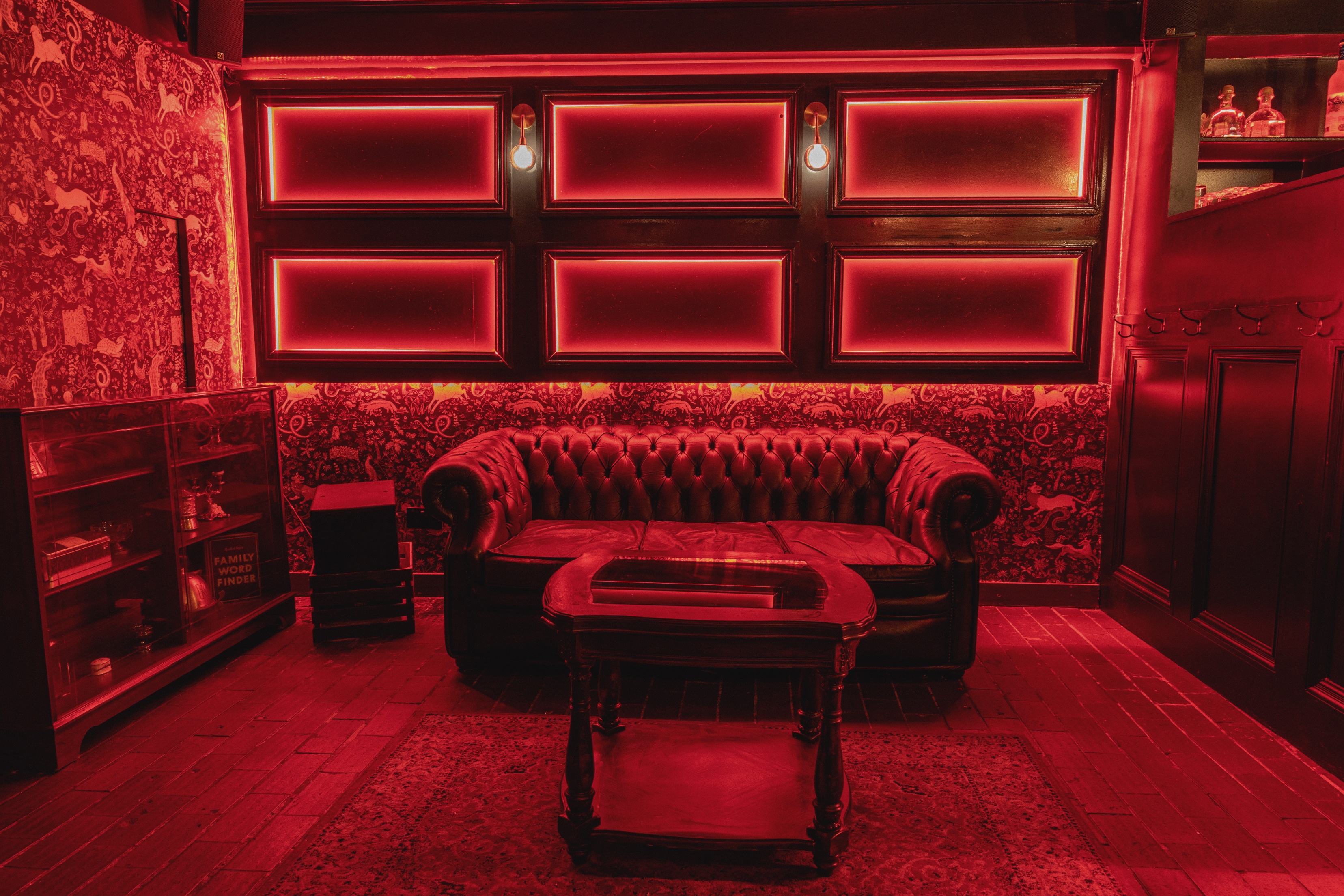 Stylish red lounge with plush leather sofa, perfect for networking events and gatherings.