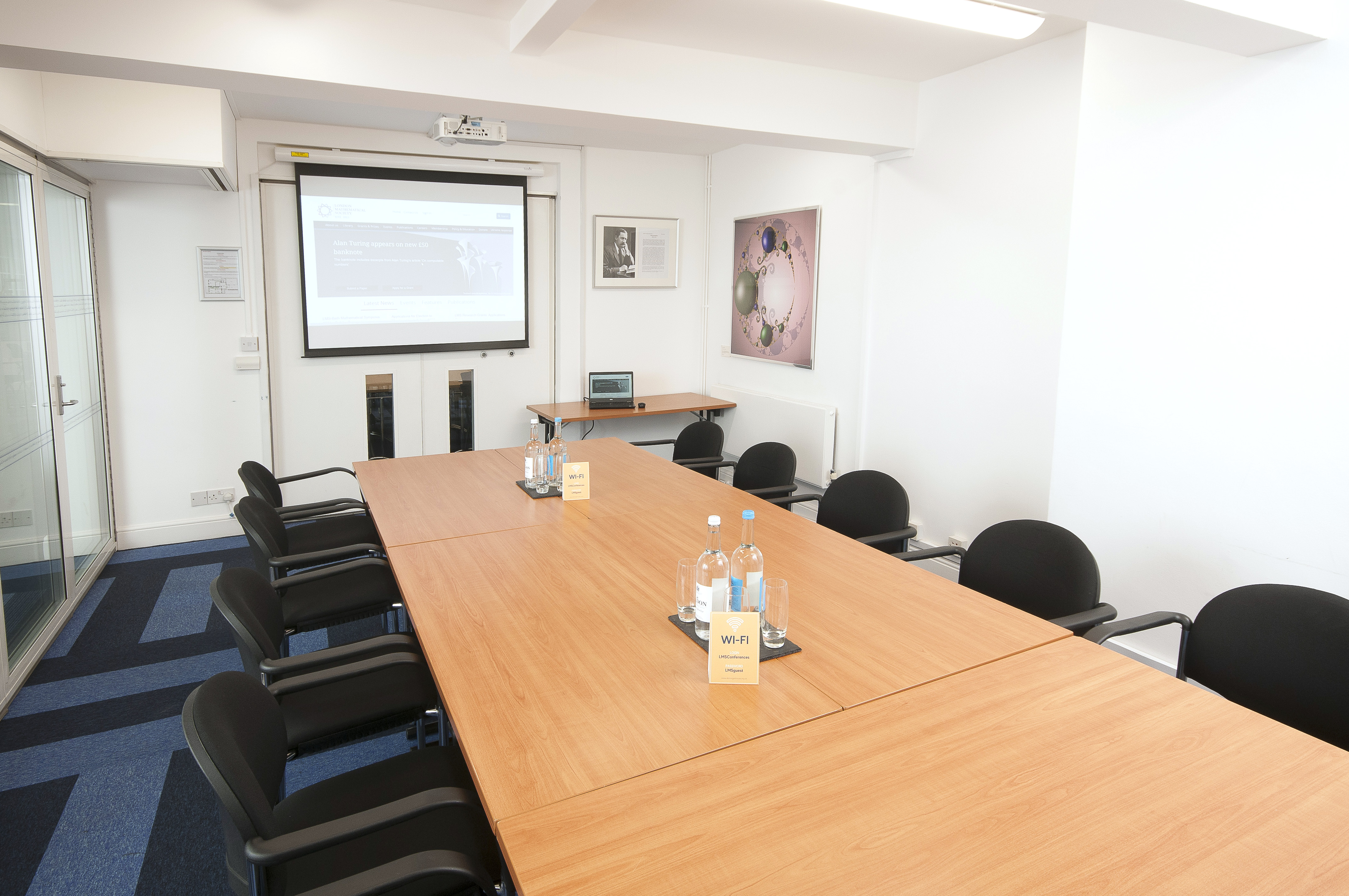 Burnside Room in De Morgan House: modern meeting space with large wooden table for events.