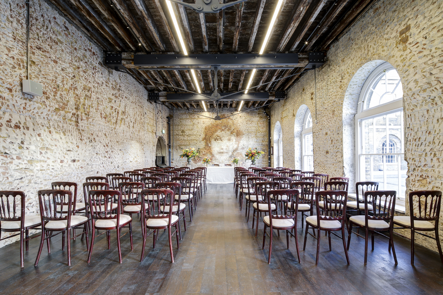 "Knight Gallery event space with rustic stone walls, ideal for ceremonies and presentations."
