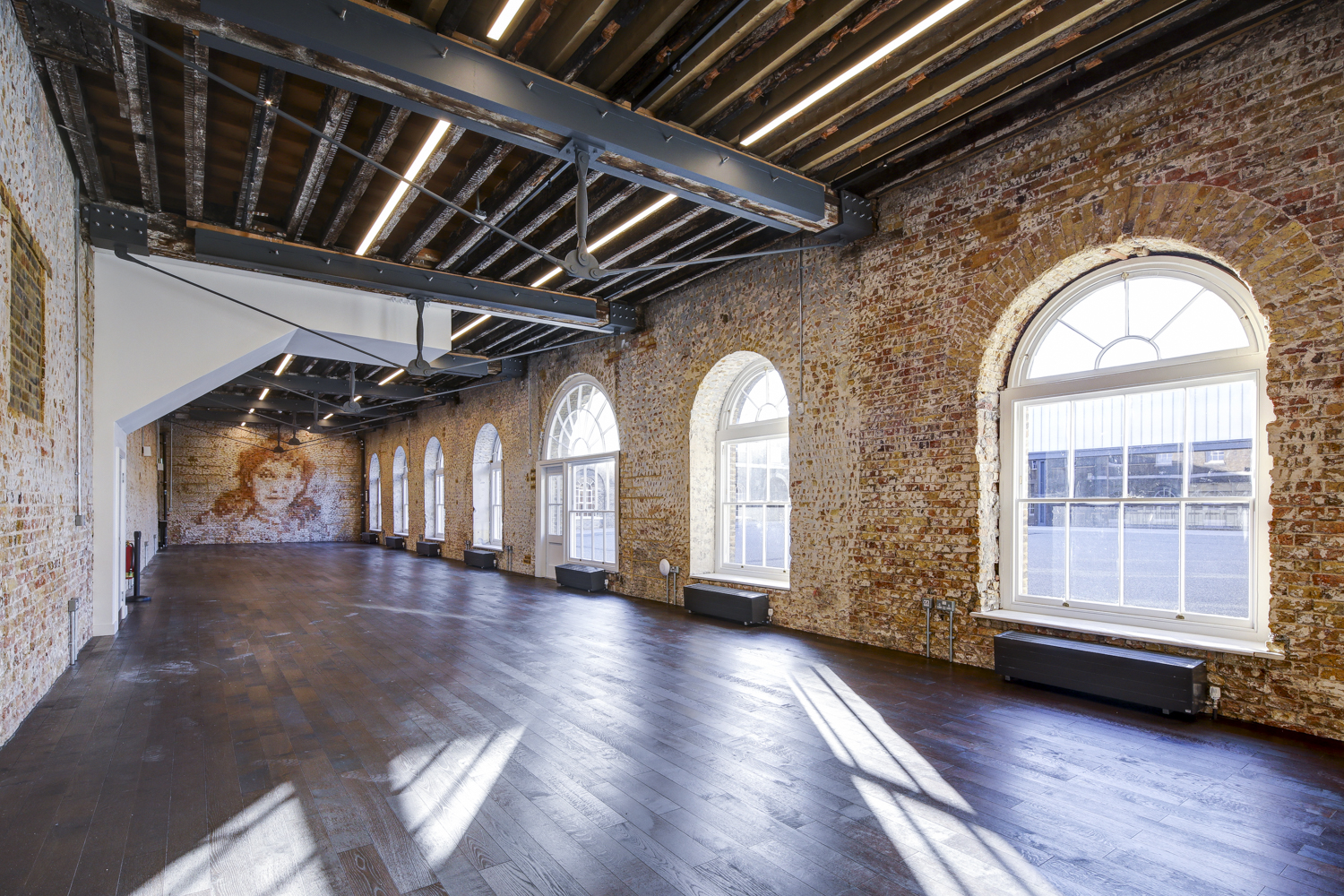 Spacious Knight Gallery venue with exposed brick, perfect for corporate events and workshops.
