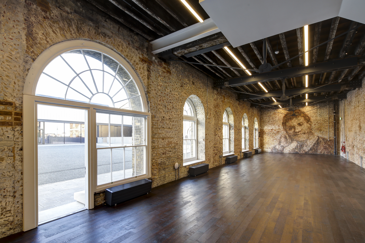 Spacious Knight Gallery venue with exposed brick, ideal for corporate and creative events.