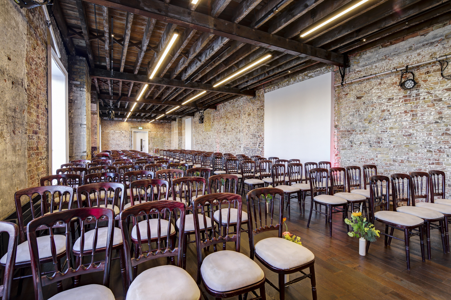 Beanfeast event space in Woolwich Works with rustic brick walls, ideal for seminars and gatherings.