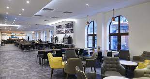 Modern event space with large windows, perfect for workshops and receptions.