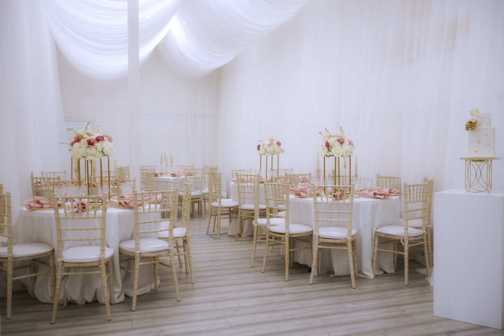 Elegant event space with round tables, ideal for weddings and upscale gatherings.