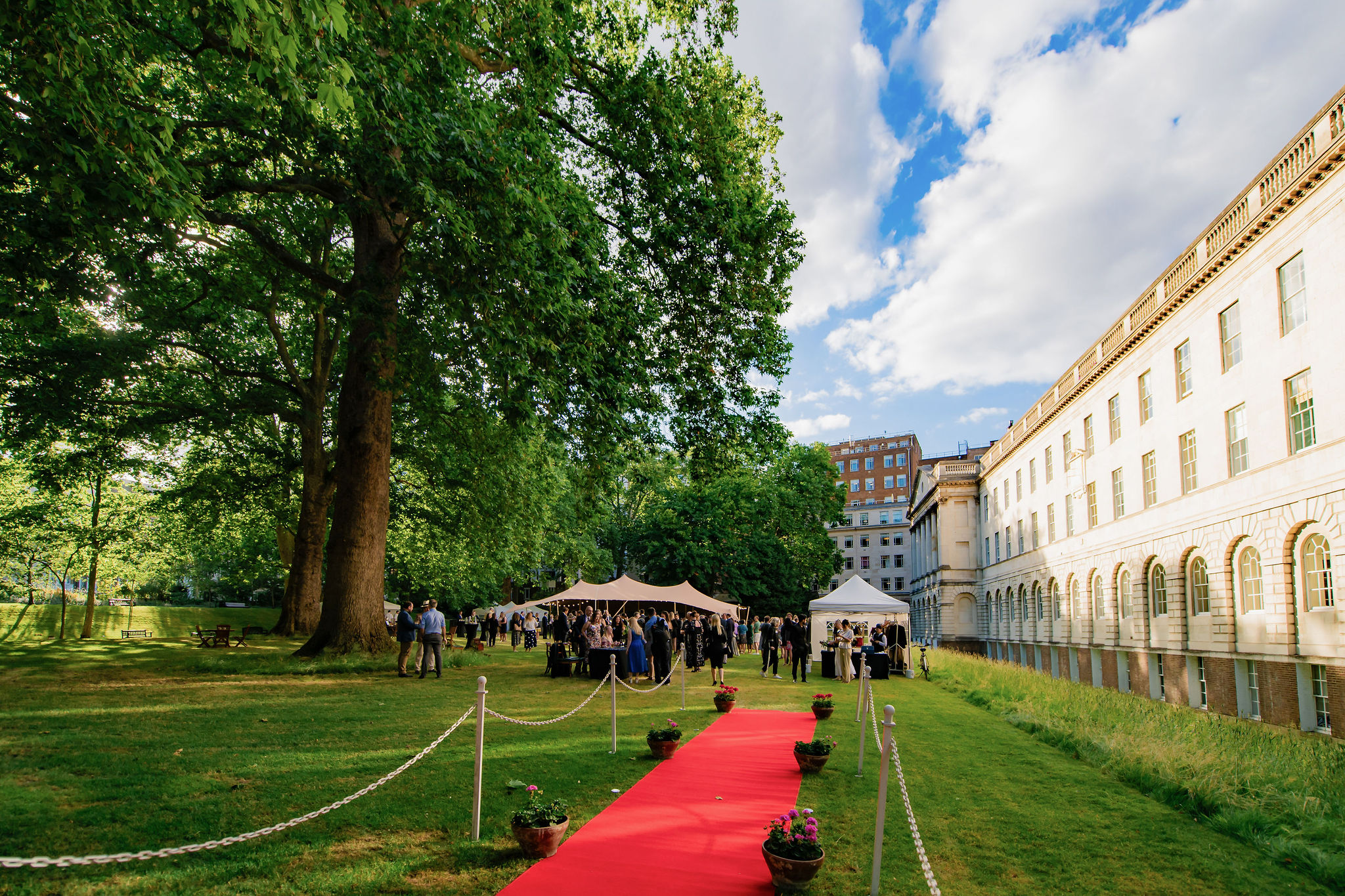 Elegant outdoor summer event with red carpet at Lincoln's Inn North Lawn.