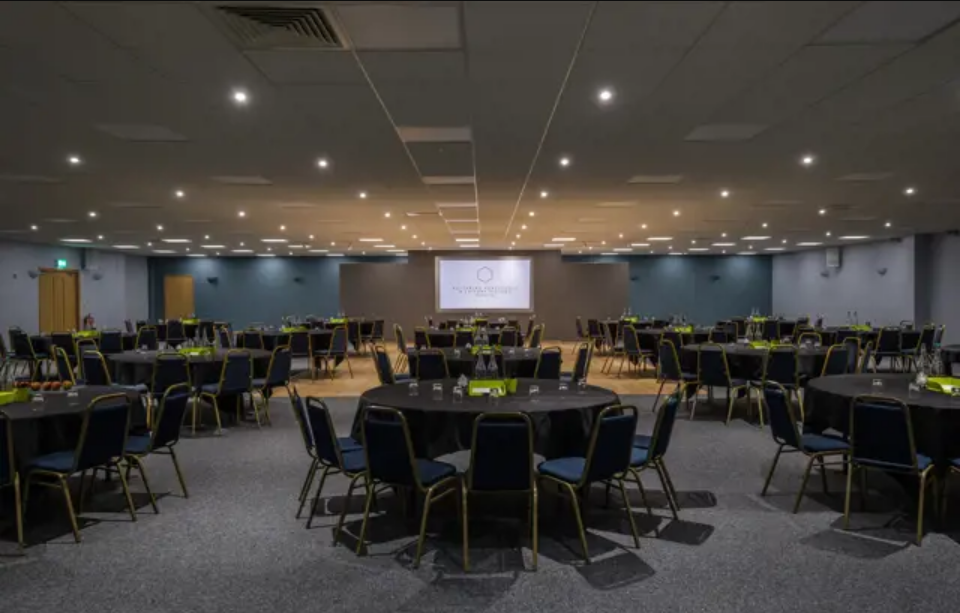 Fair Isle event space with round tables, ideal for corporate banquets and conferences.