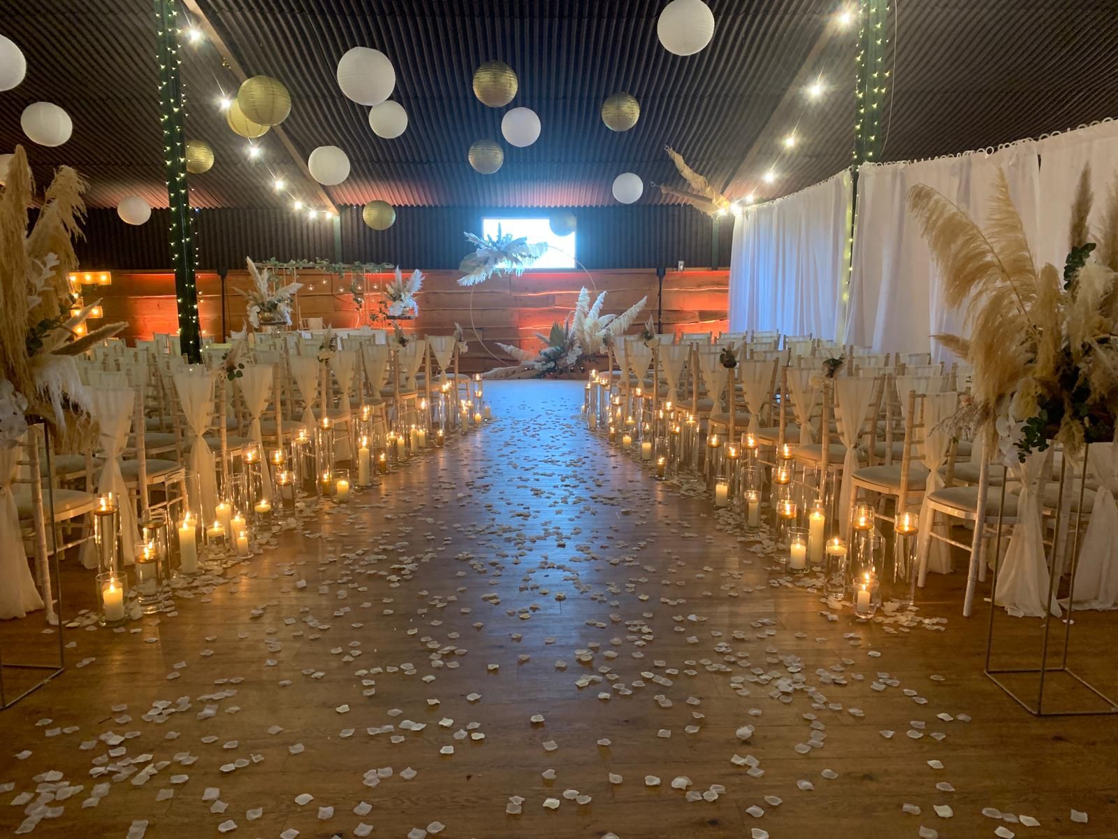 Stock Farm Barn wedding venue with elegant chairs, drapery, and romantic decor.