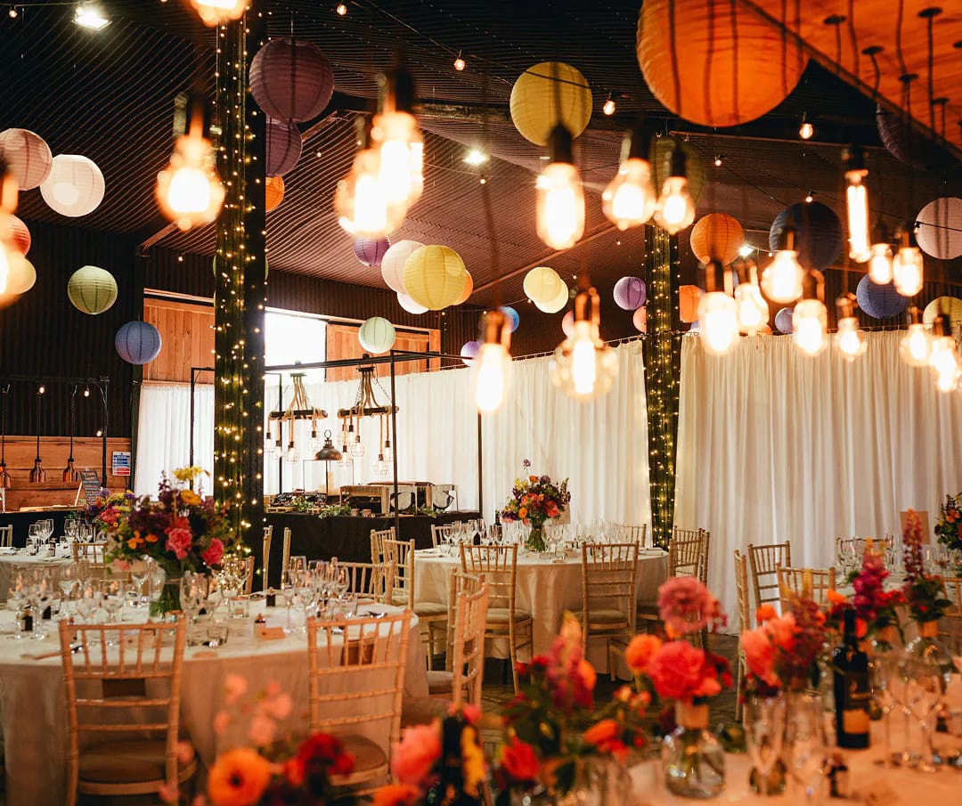 Stock Farm Barn wedding venue with elegant tables and vibrant floral centerpieces.