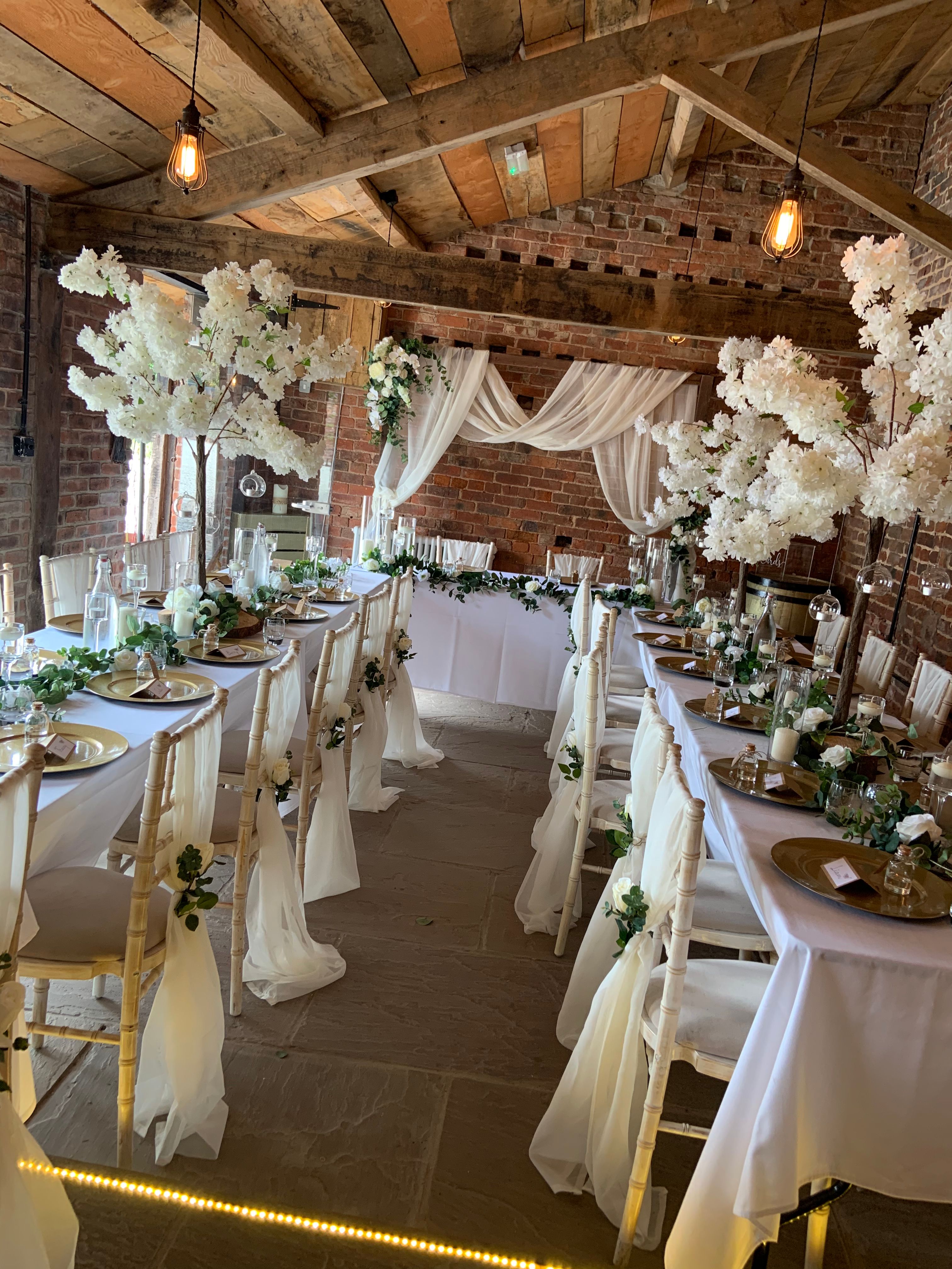 Stock Farm Barn wedding setup with elegant tables and floral centerpieces.
