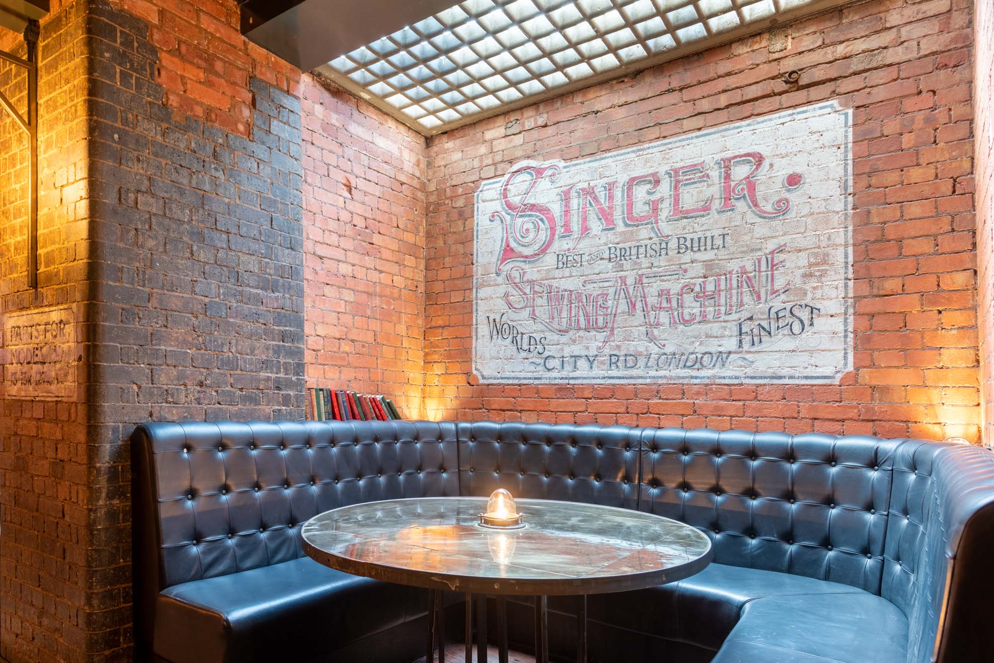 Cozy 5CC Cocktail Bar with leather booth, ideal for meetings and gatherings.