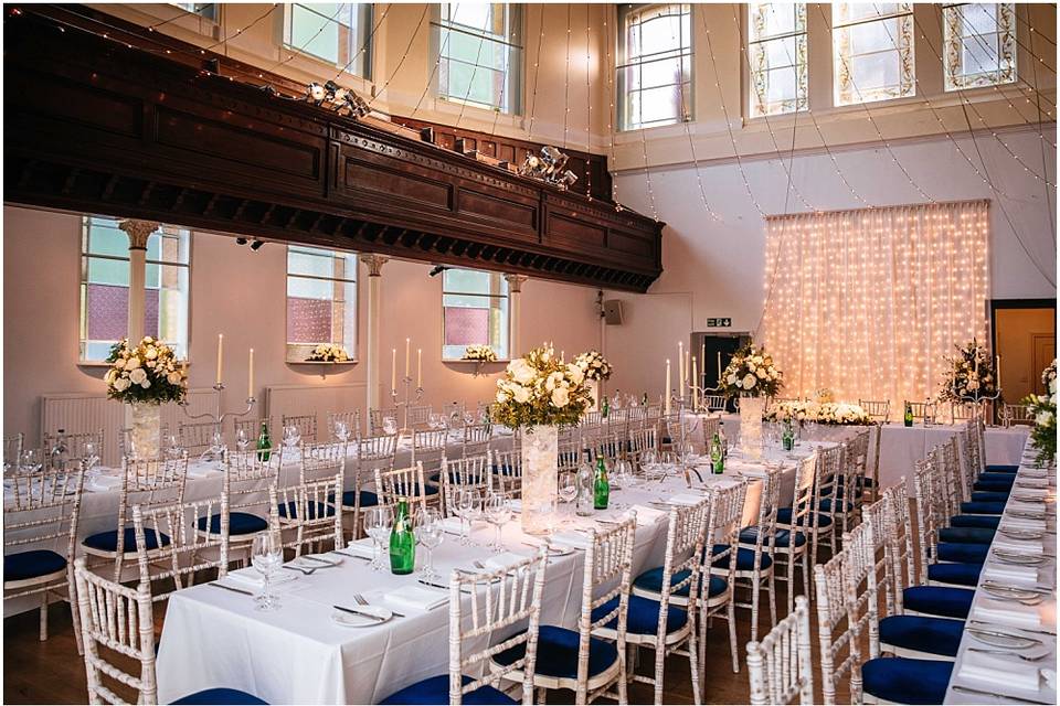 Elegant Upper Hall event space with floral centerpieces, ideal for weddings and gatherings.