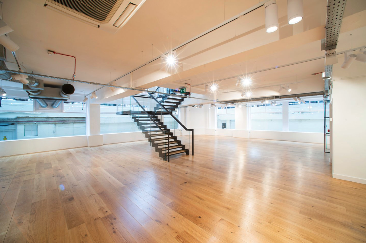 Versatile event space with polished wooden floors and natural light at 13-14 Margaret Street.