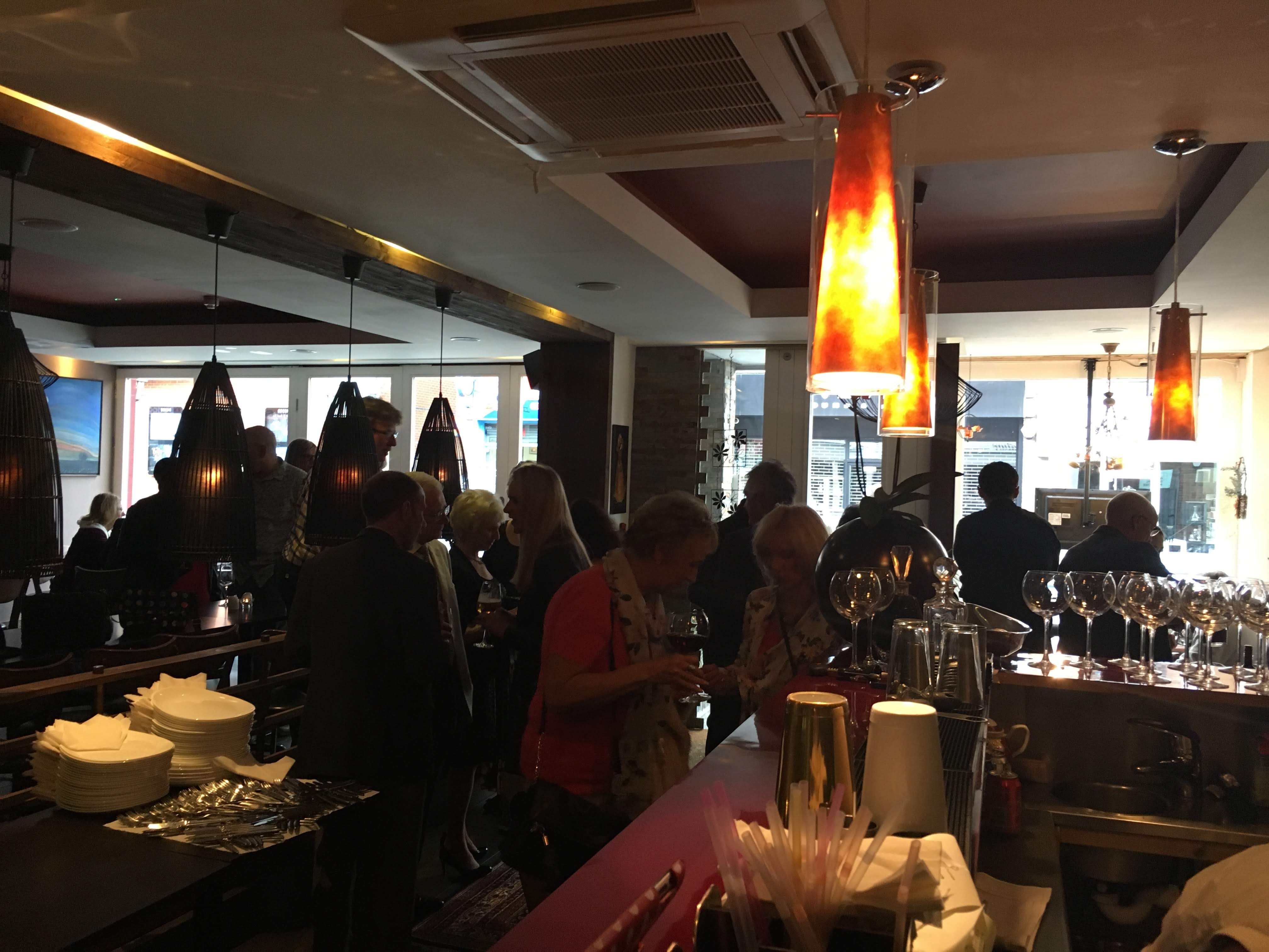 Vibrant networking event at Miniature Restaurant with modern decor and warm lighting.