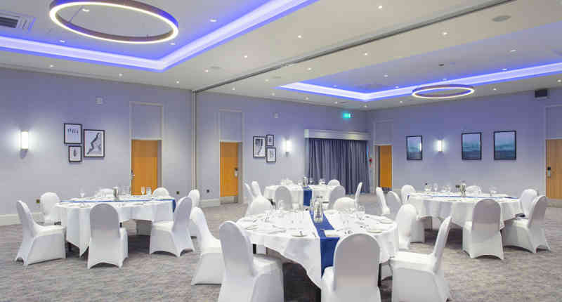 Elegant event space at Sedgebrook Hall with round tables for weddings and corporate gatherings.