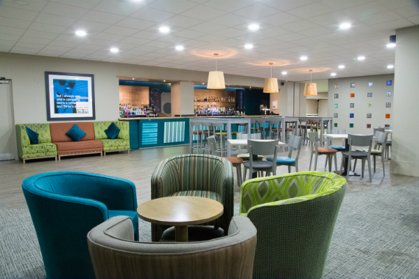 Modern lounge area in Knighton Suite, Yarnfield Park for networking and events.