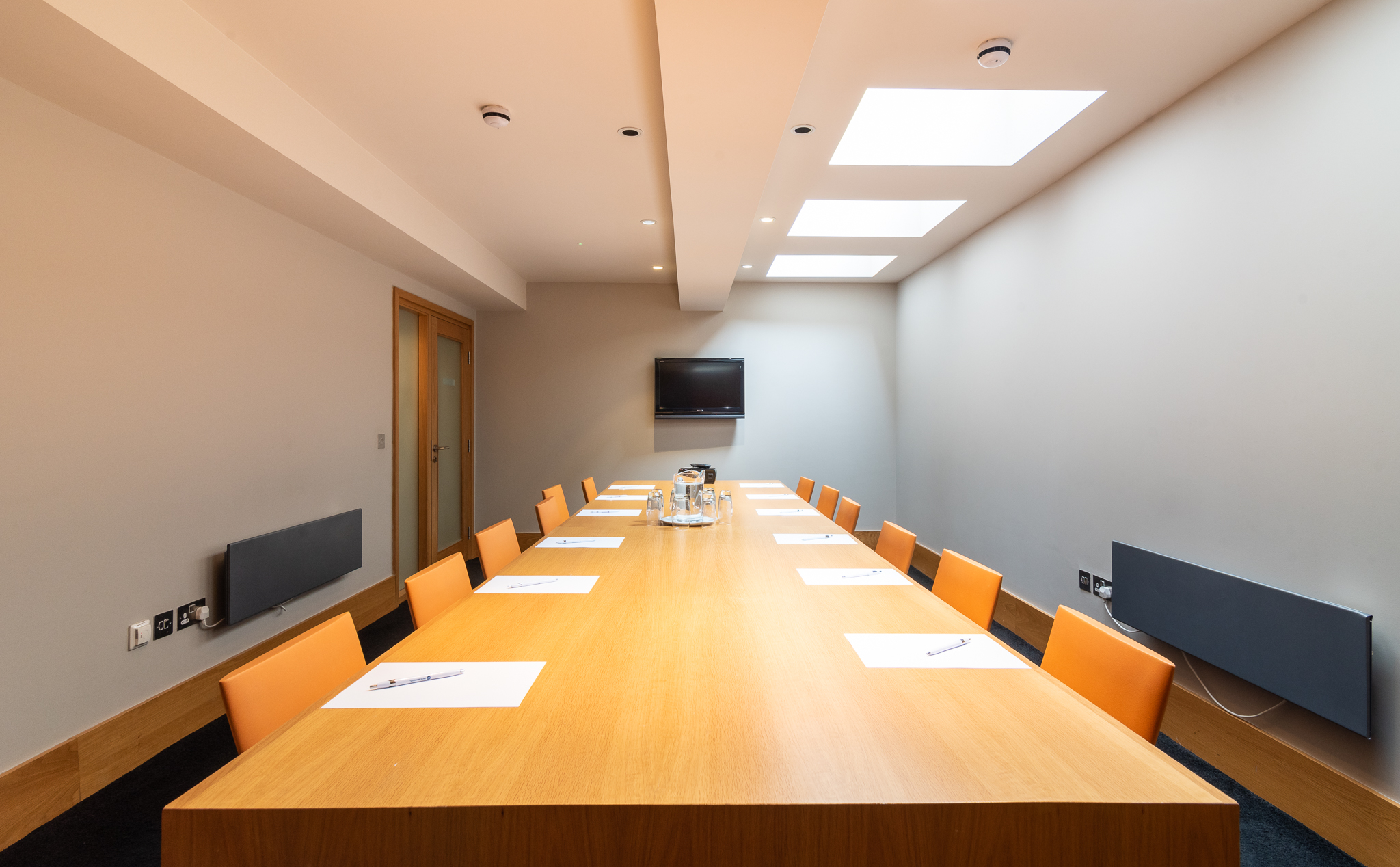 Modern conference room in Harrogate with long table, ideal for meetings and presentations.