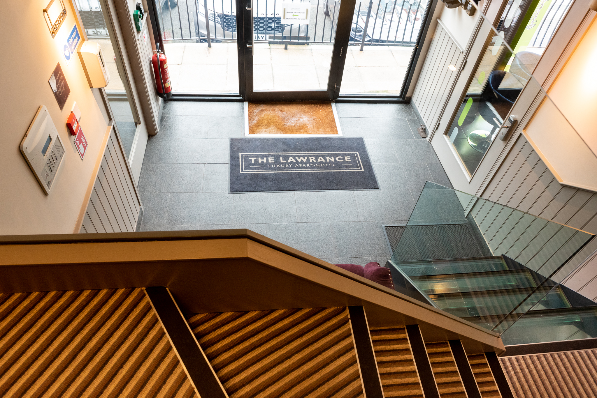 Modern conference room entrance with elegant staircase, ideal for meetings and events.