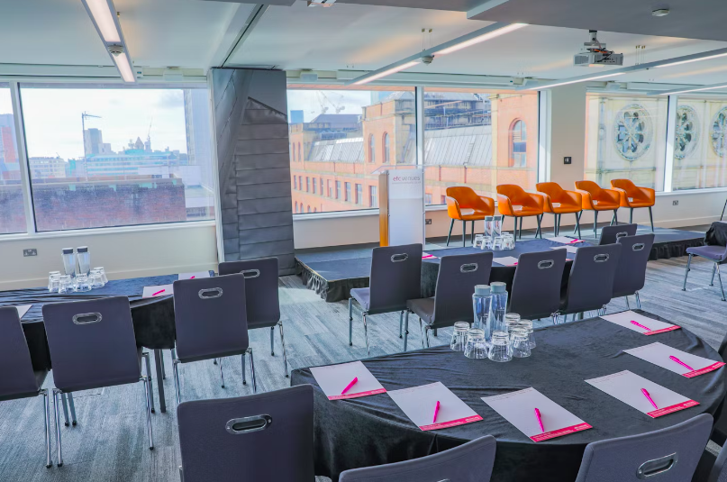 Modern meeting space in Etc.venues Manchester with city skyline, ideal for events and presentations.