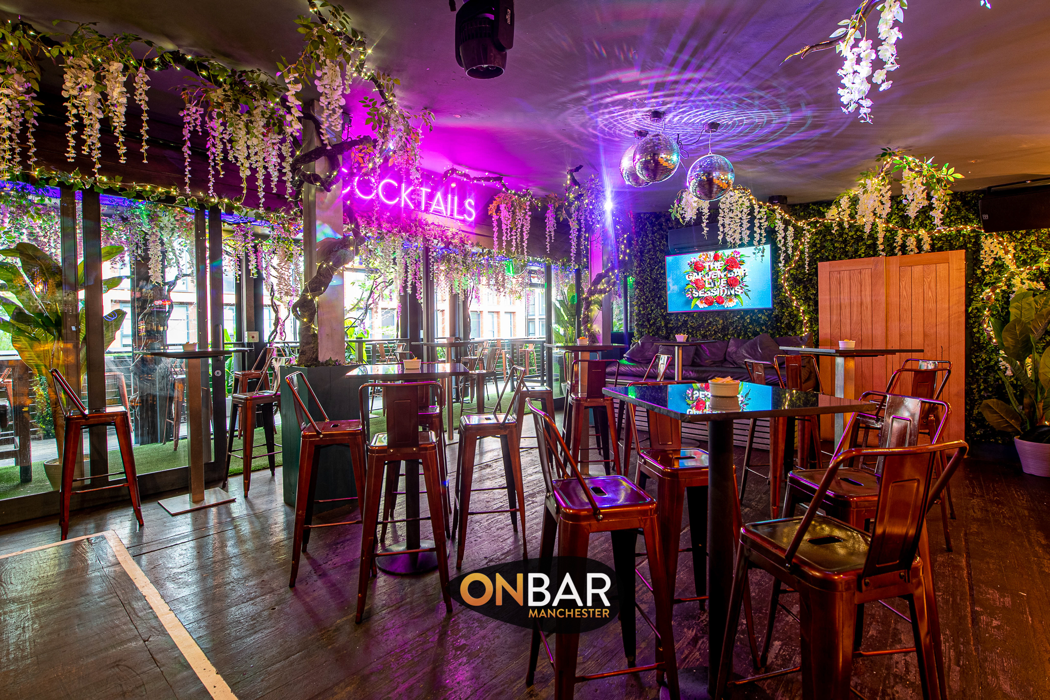 Vibrant ONBAR Manchester event space with stylish tables, perfect for social gatherings.