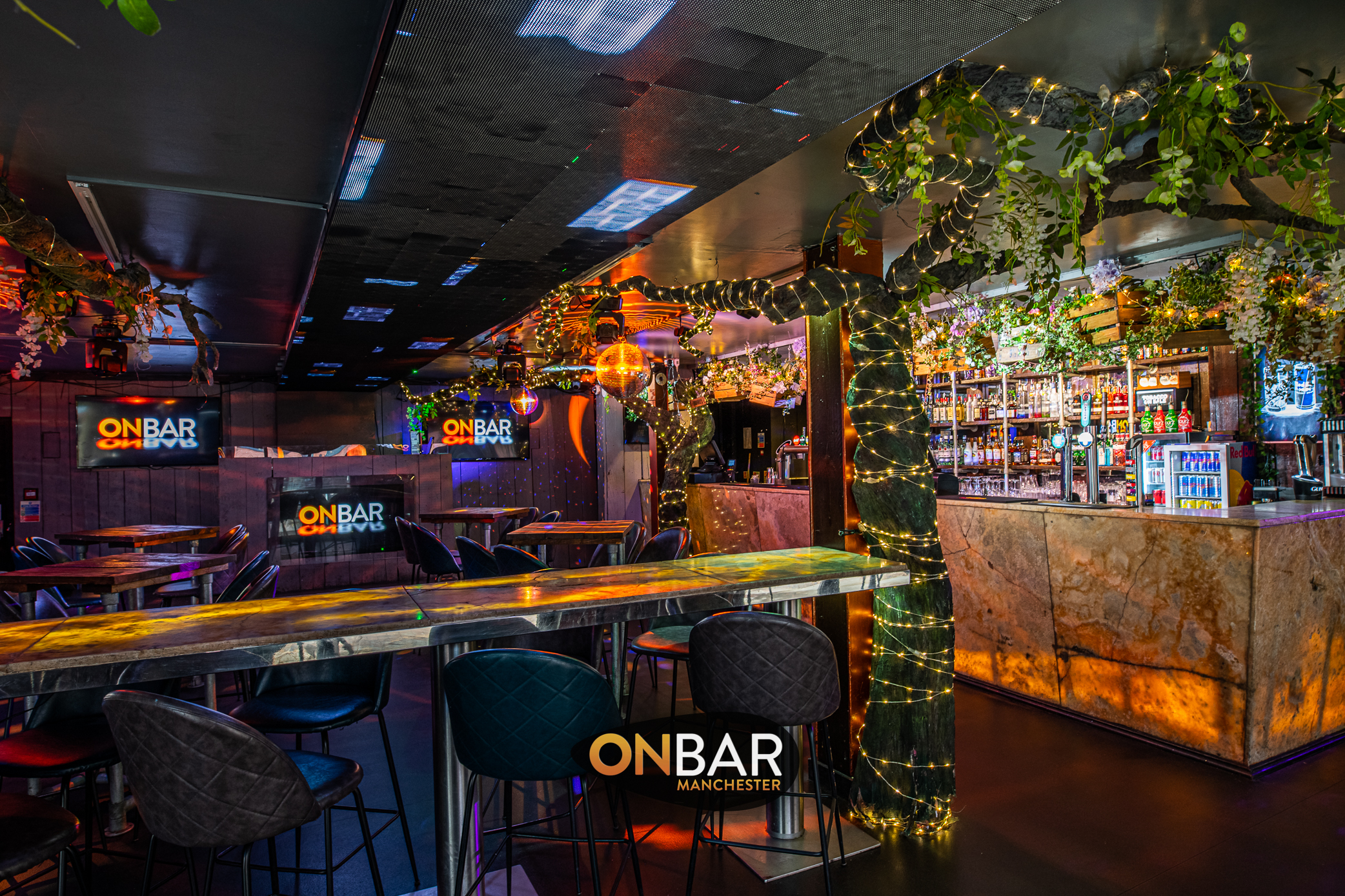 Vibrant ONBAR Manchester event space with modern bar and stylish seating for gatherings.