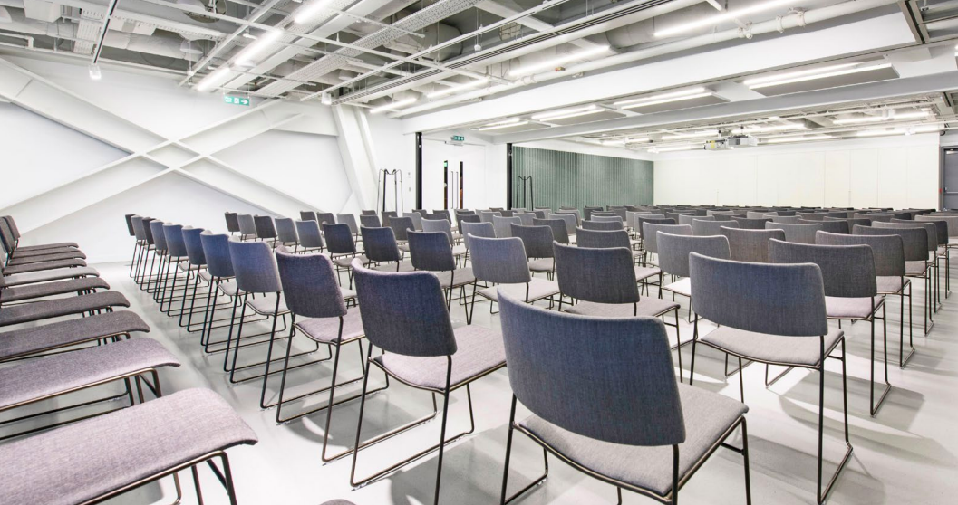 Modern event space with minimalist chairs, perfect for conferences and presentations.