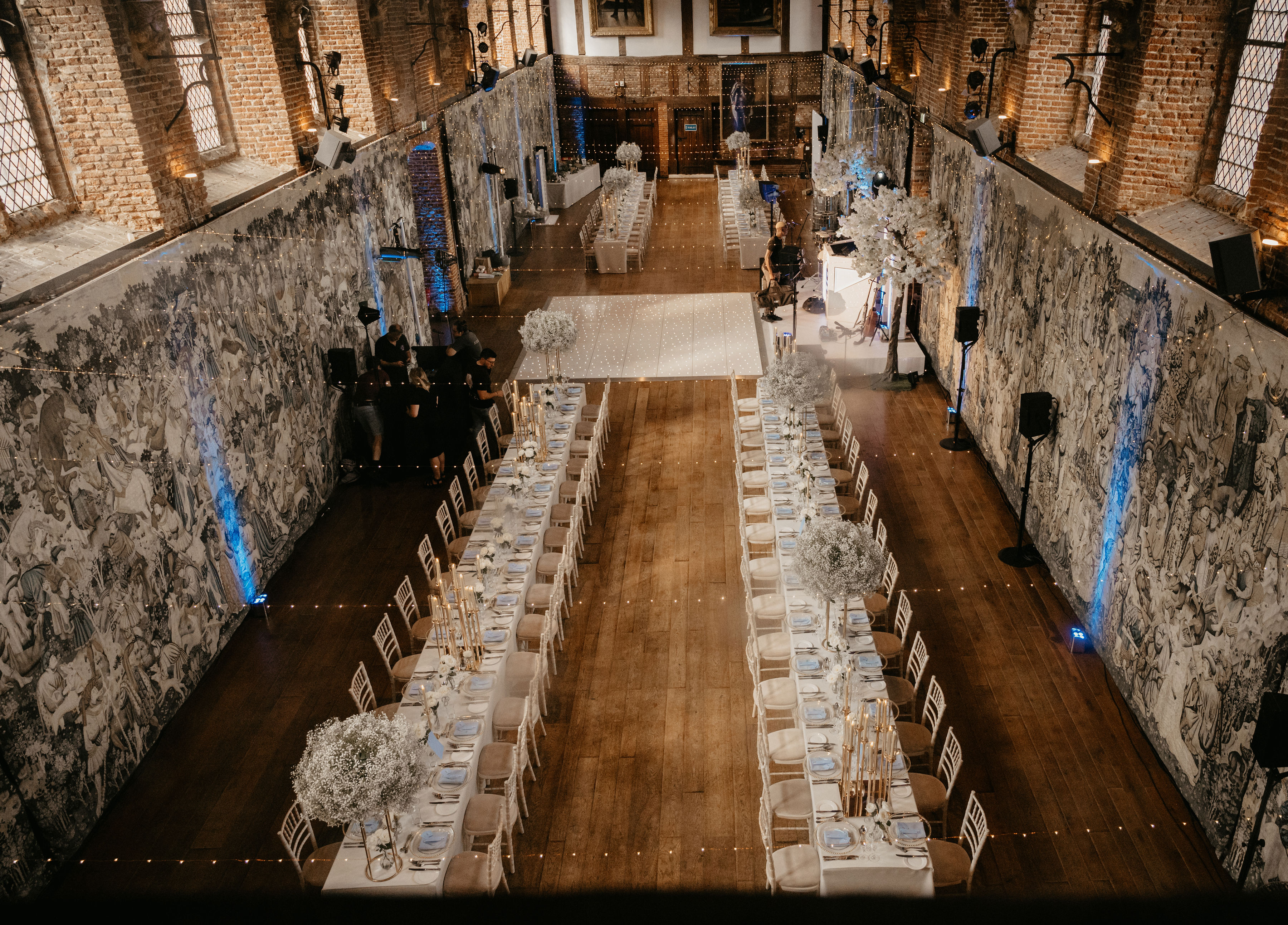 Elegant event space at The Old Palace, Hatfield House, with floral centerpieces.