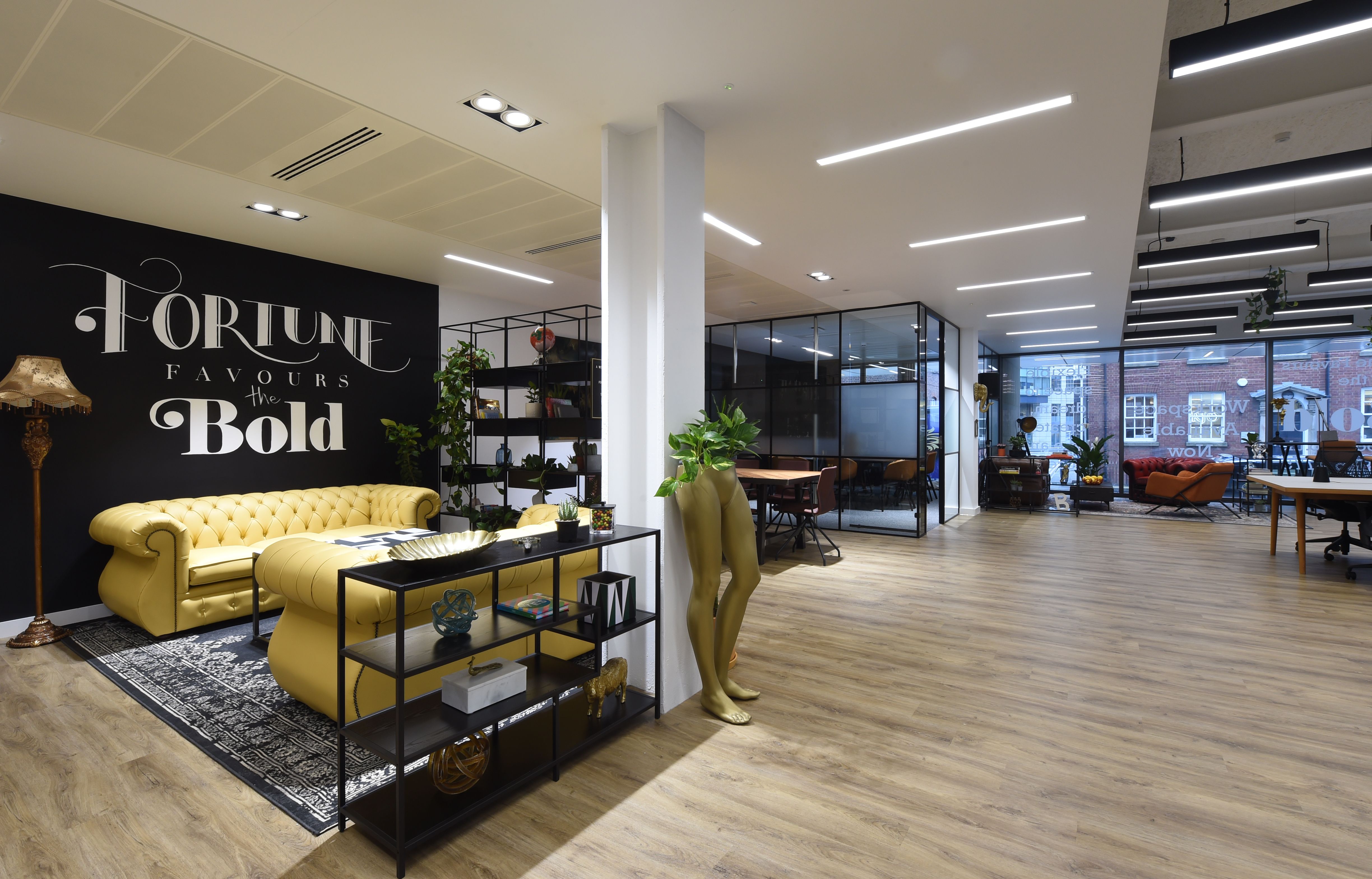 Modern Bold Members Lounge with inspiring wall art, perfect for workshops and networking.