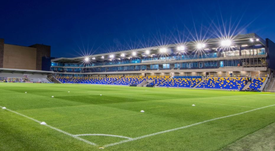 Silver Lounge at AFC Wimbledon: modern stadium with green turf for events and gatherings.