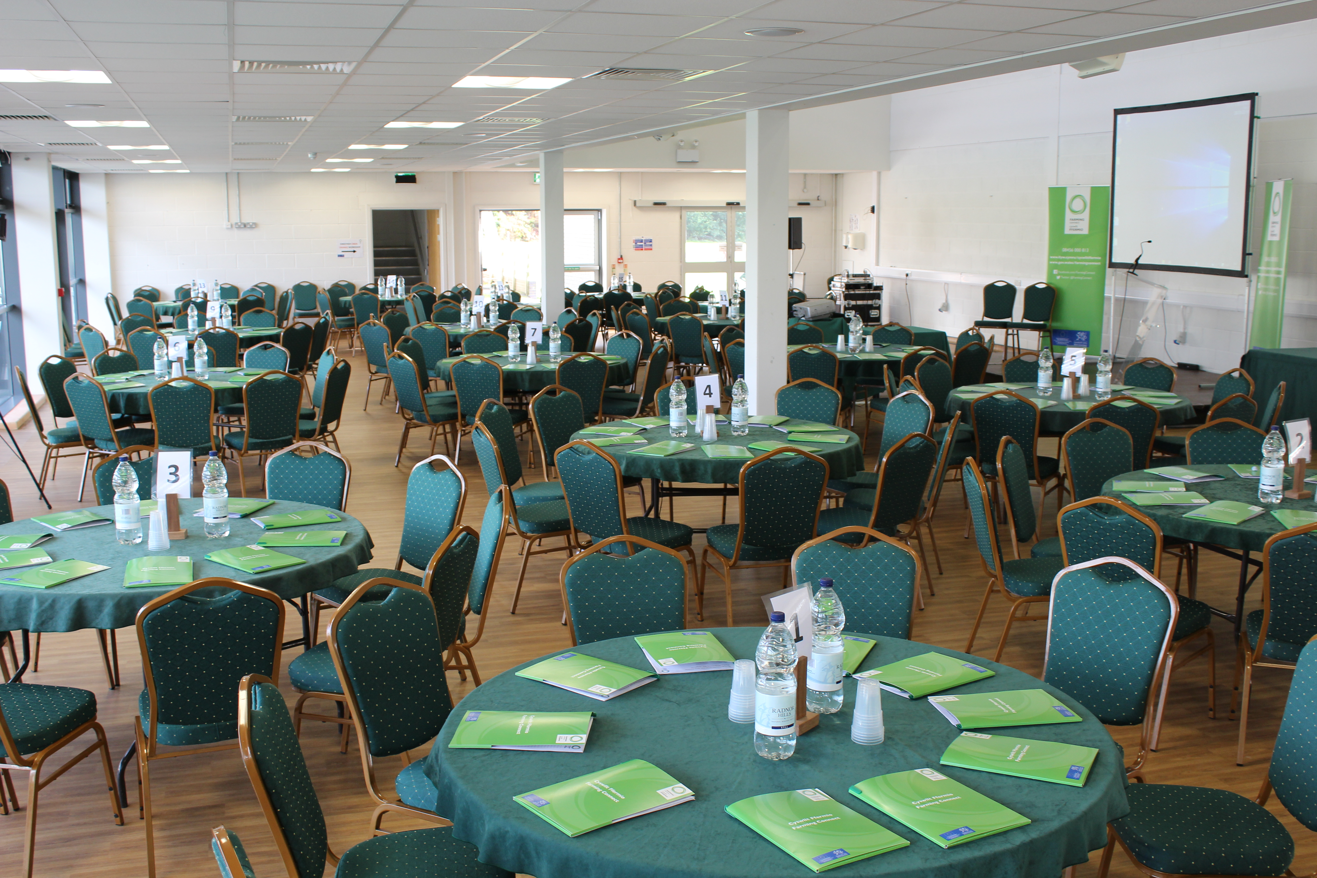 Members Centre at Royal Welsh Showground, set for a conference with green tablecloths.