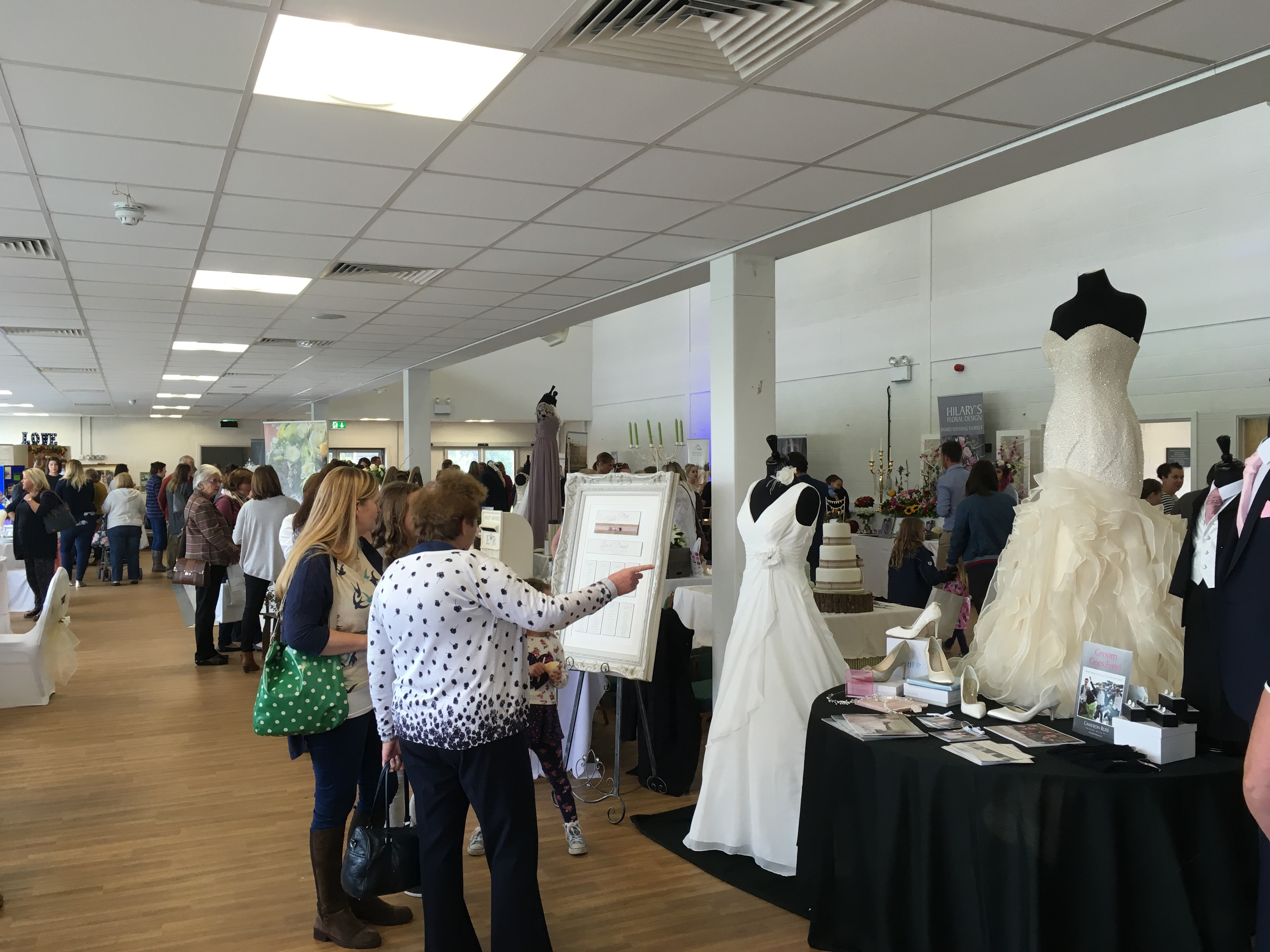 Bridal expo at Royal Welsh Showground with elegant wedding dress displays.