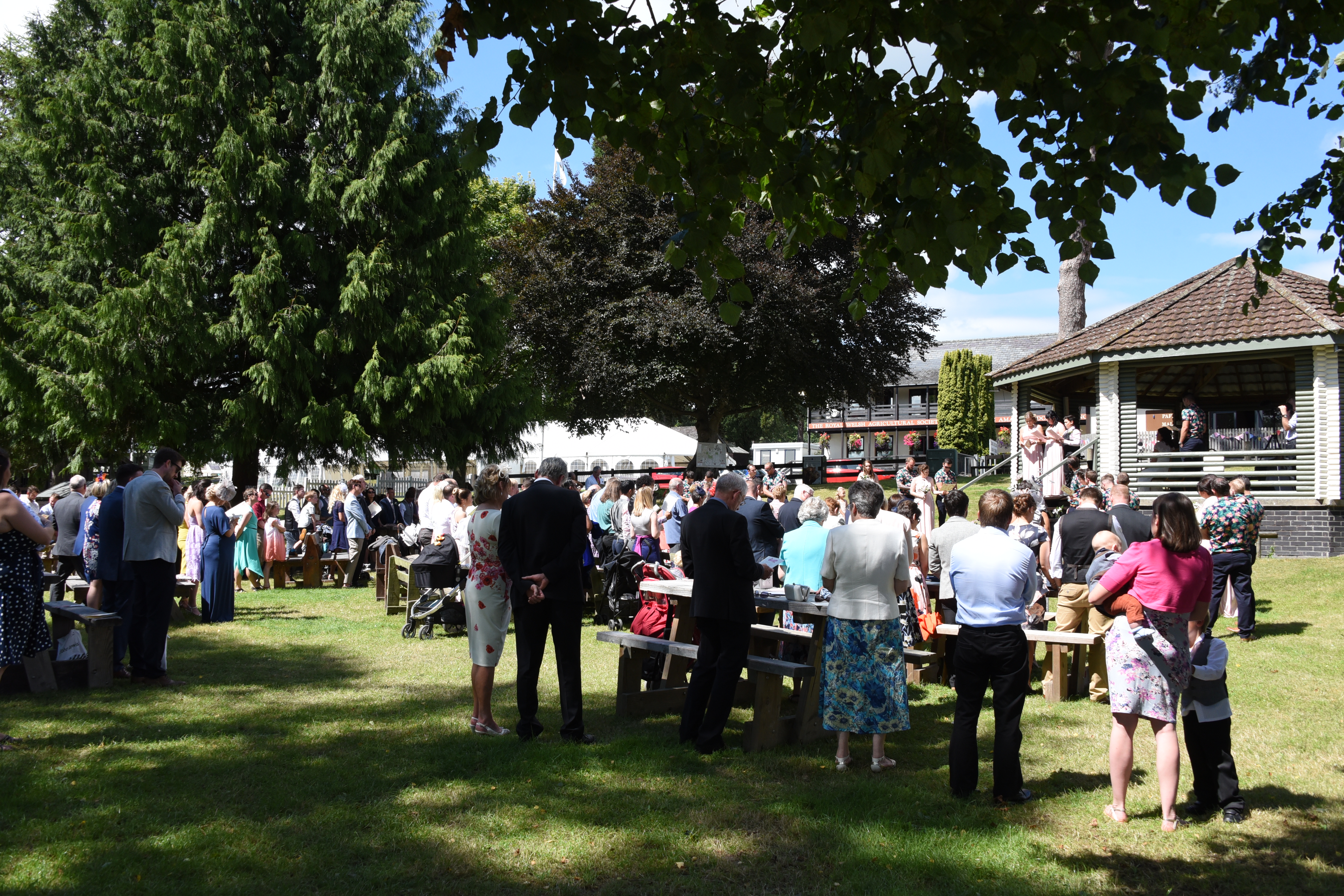 Outdoor corporate event at The Bandstand, featuring a gazebo and networking attendees.