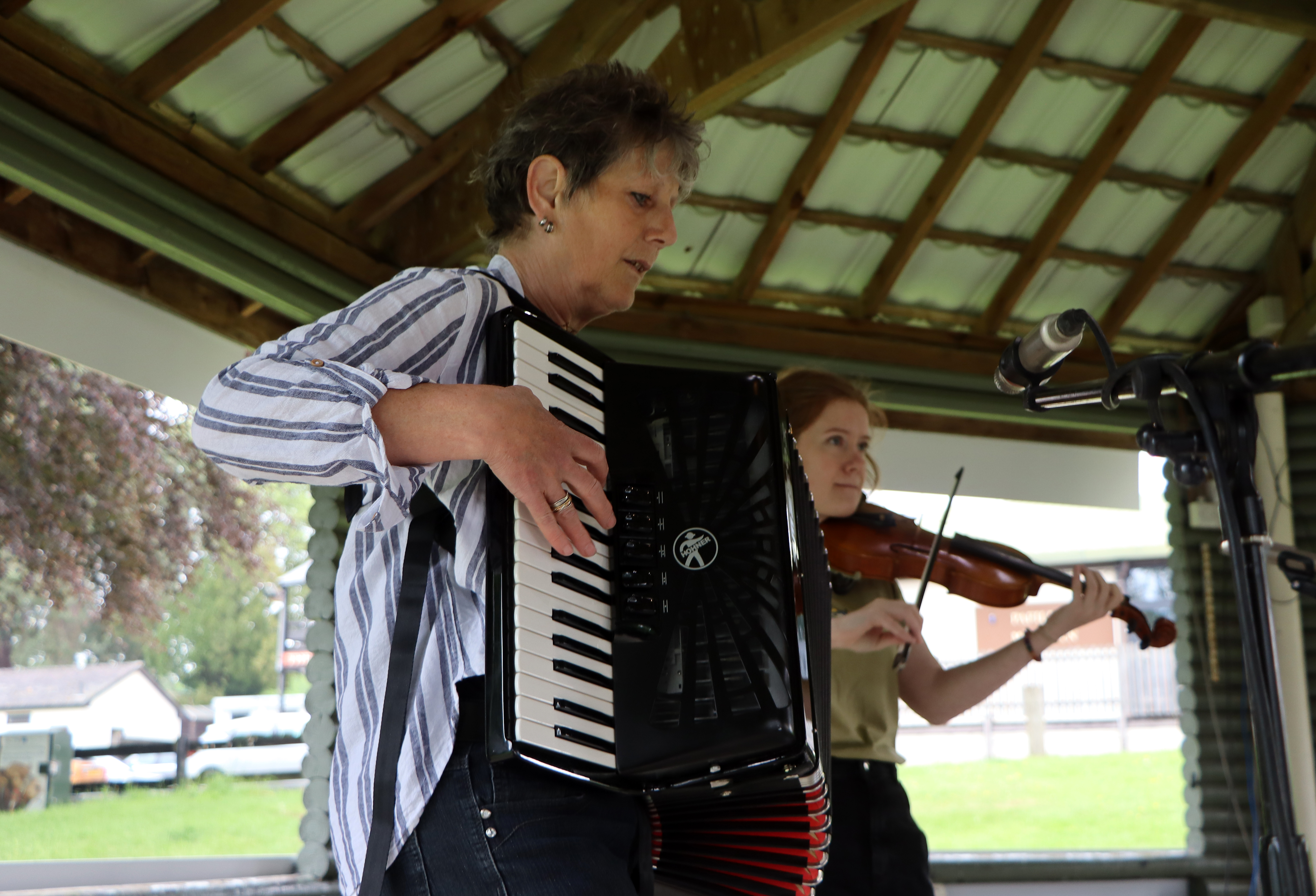 Outdoor performance at Royal Welsh Showground with accordion and violin musicians.