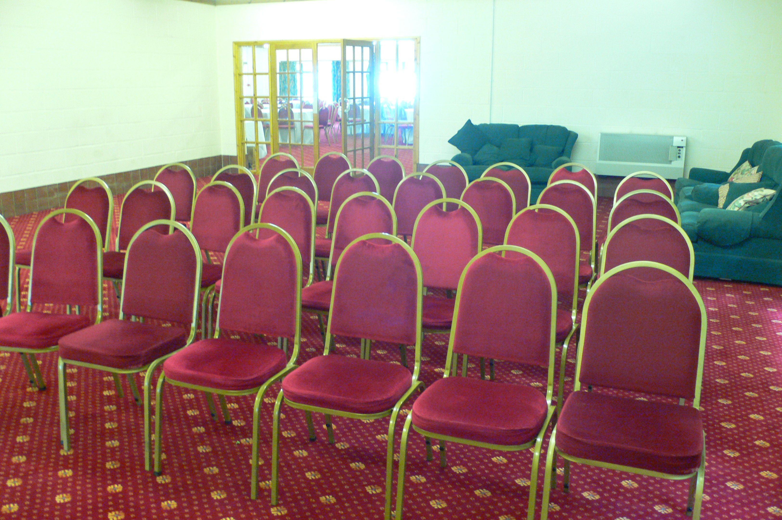 Hafod a Hendre meeting space with red chairs for presentations and networking events.