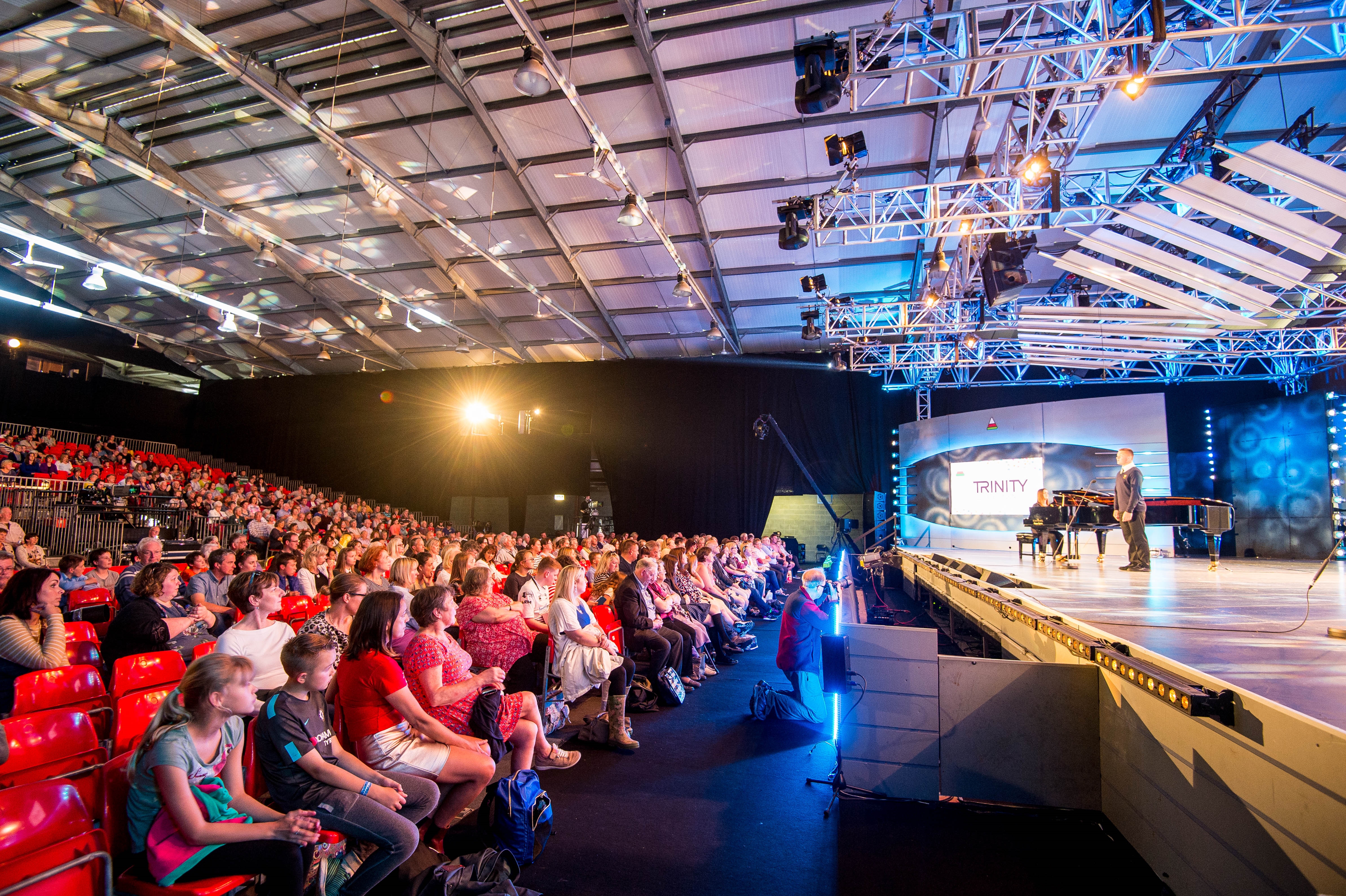 Royal Welsh Showground Exhibition Hall with vibrant stage setup for engaging events.