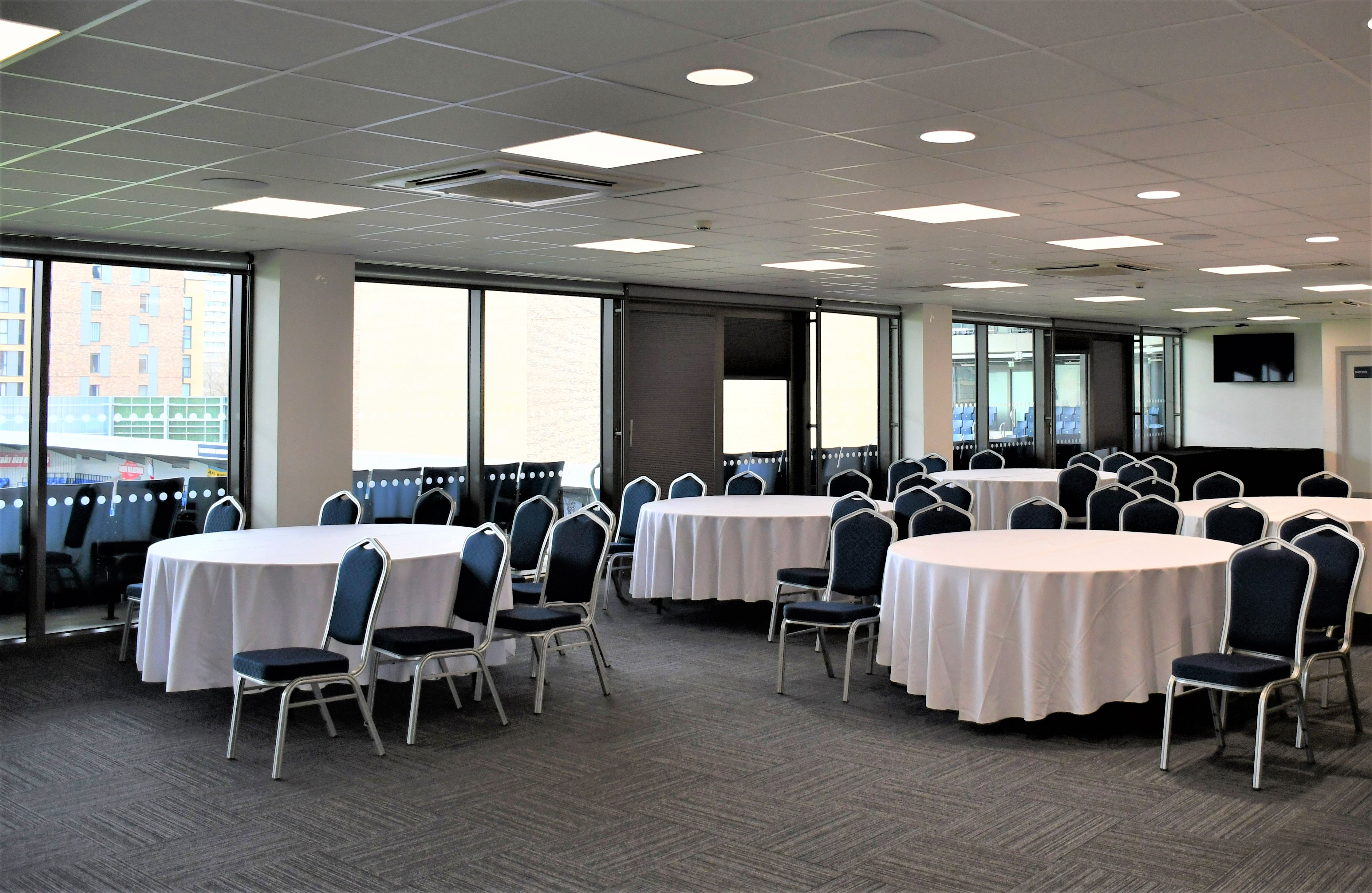 Platinum Lounge at AFC Wimbledon: versatile event space with round tables for banquets.