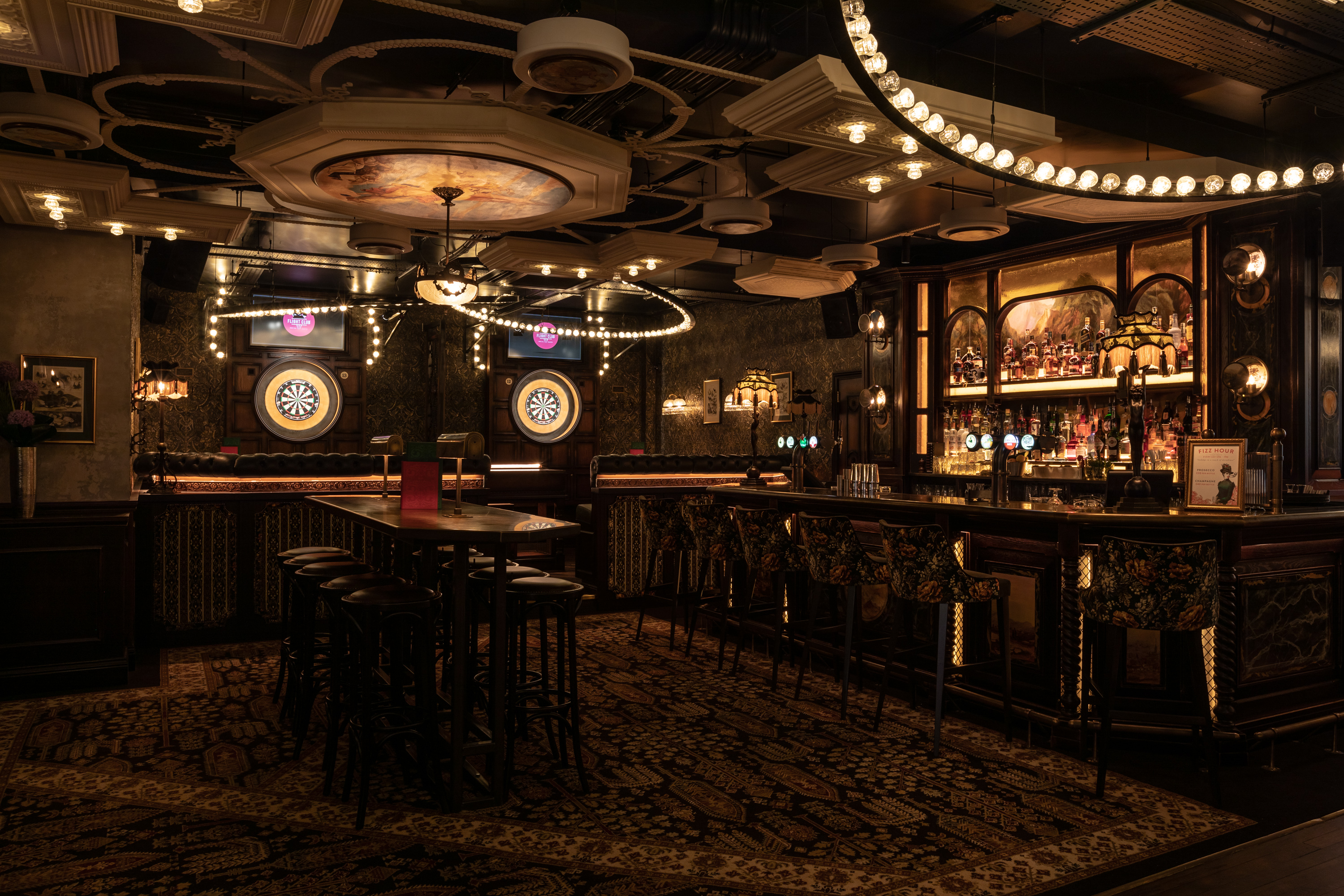 Stylish bar with dartboards in Flight Club Birmingham, perfect for networking events.