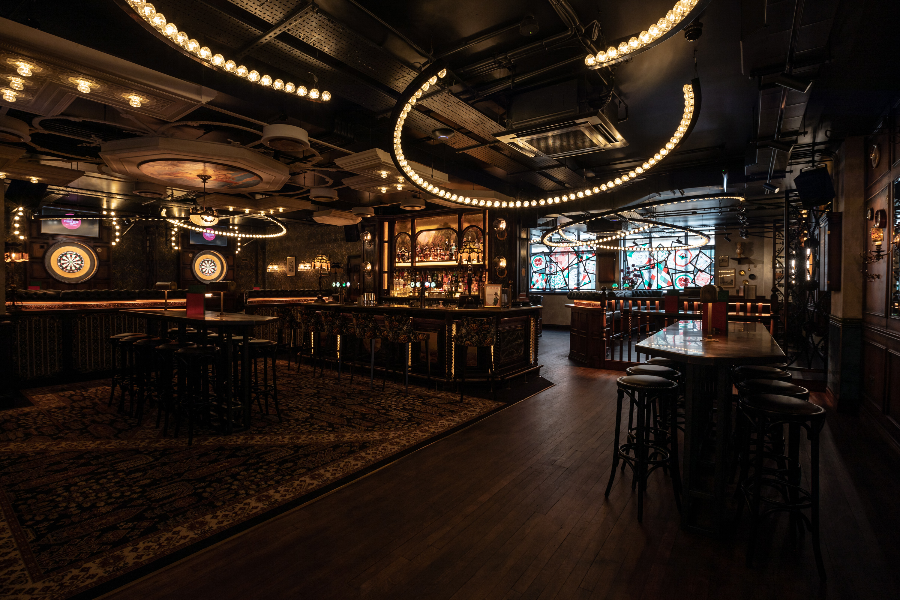 Stylish event space at Flight Club Birmingham with modern bar and ambient lighting.