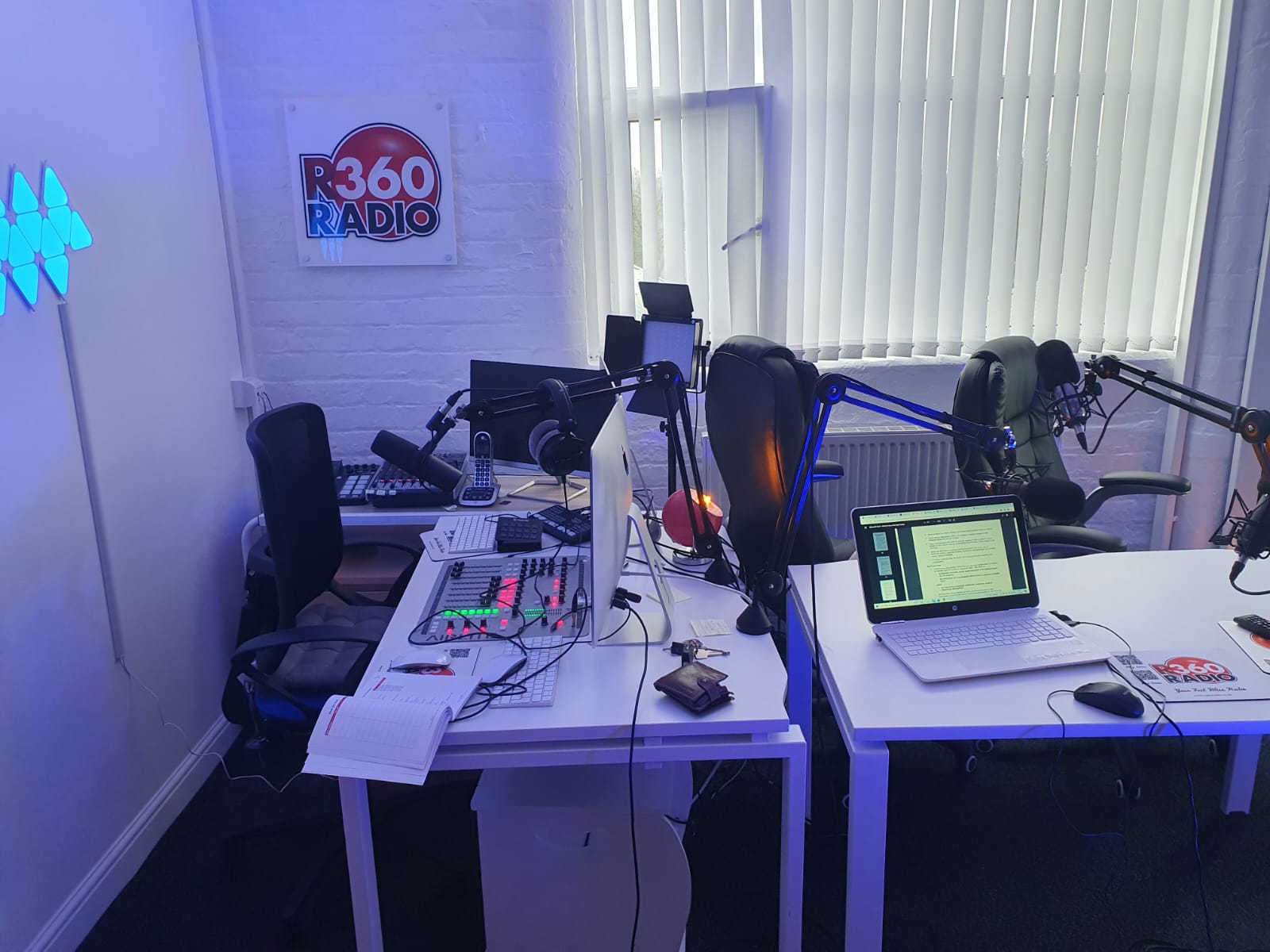 Modern podcast studio with dual workstations, ideal for live events and recordings.