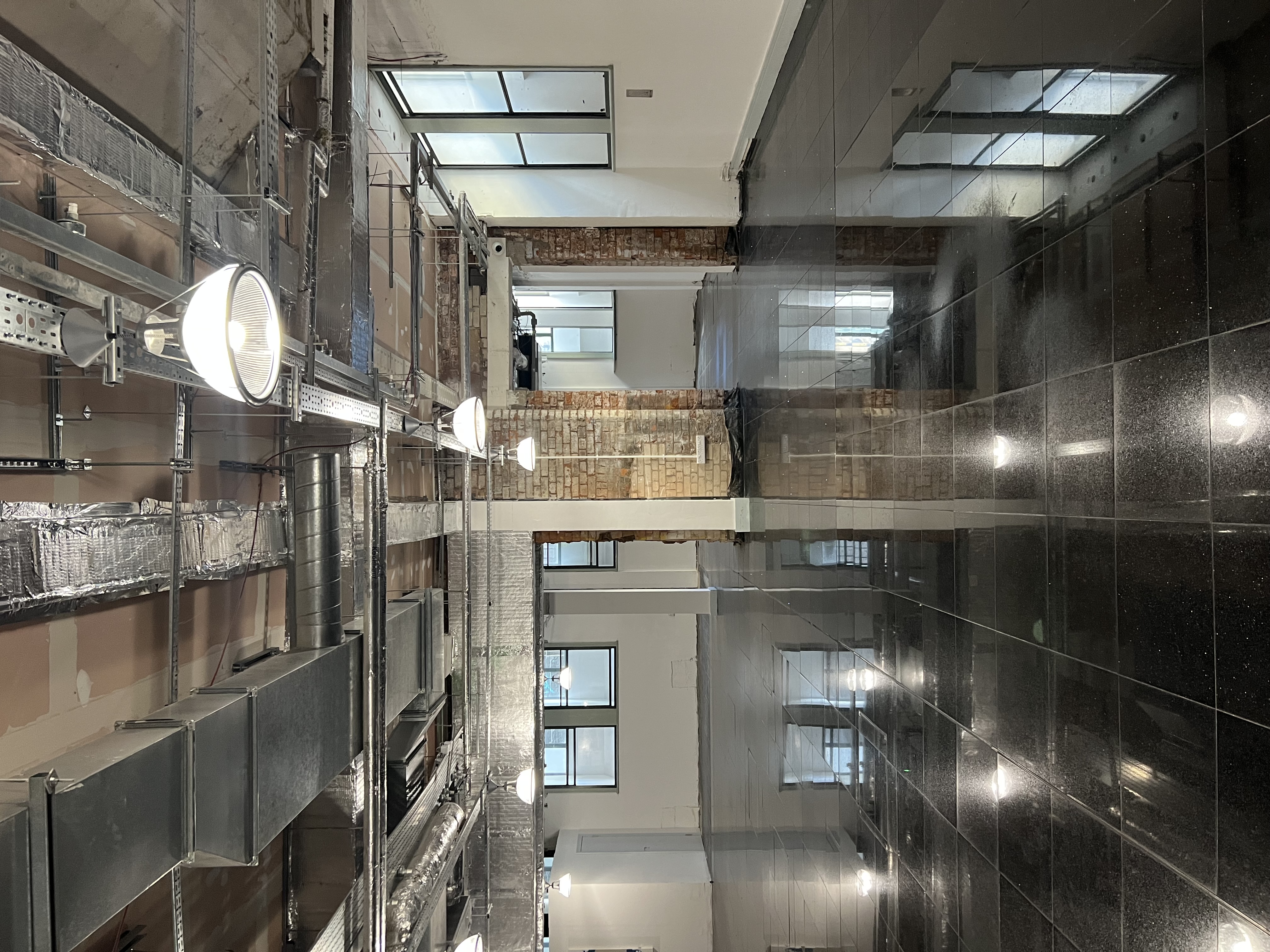 Versatile event space with polished floors and industrial design for corporate meetings.