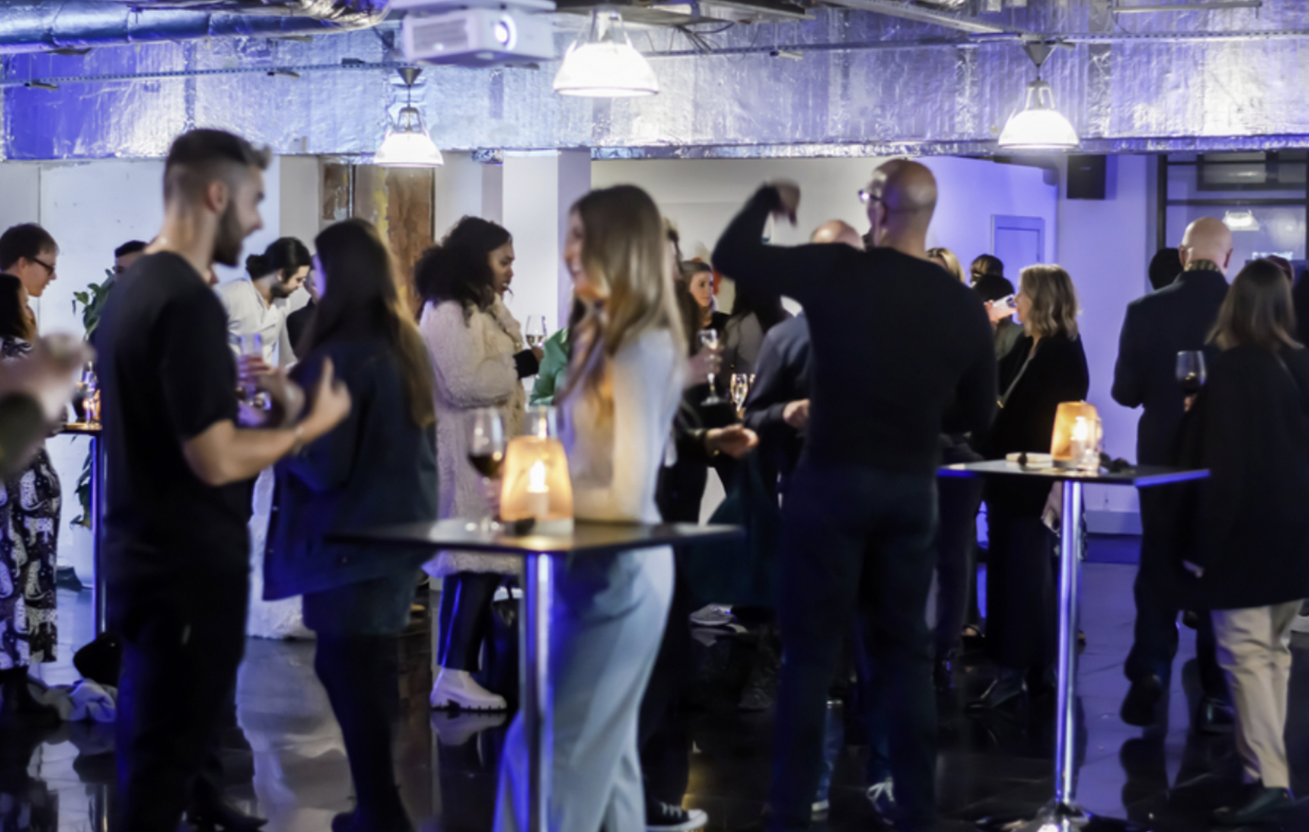 Vibrant networking event at The Alan with engaged attendees and stylish decor.