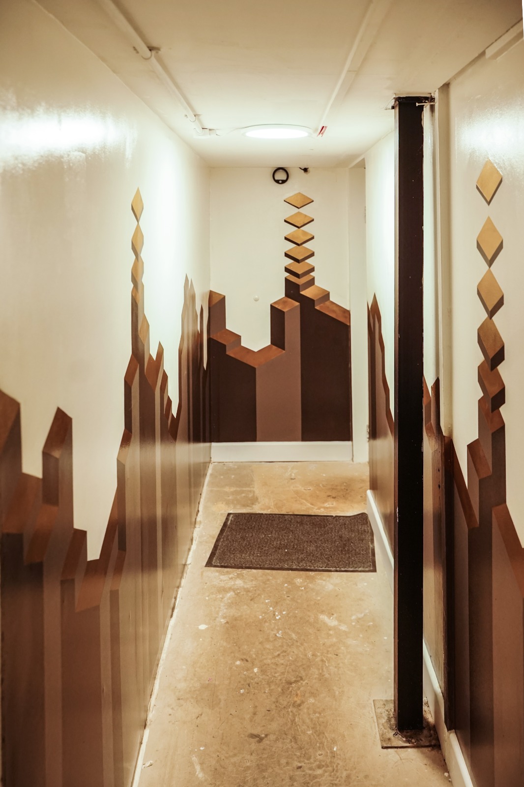 Modern hallway with geometric art at Black Box Studio, ideal for events and networking.