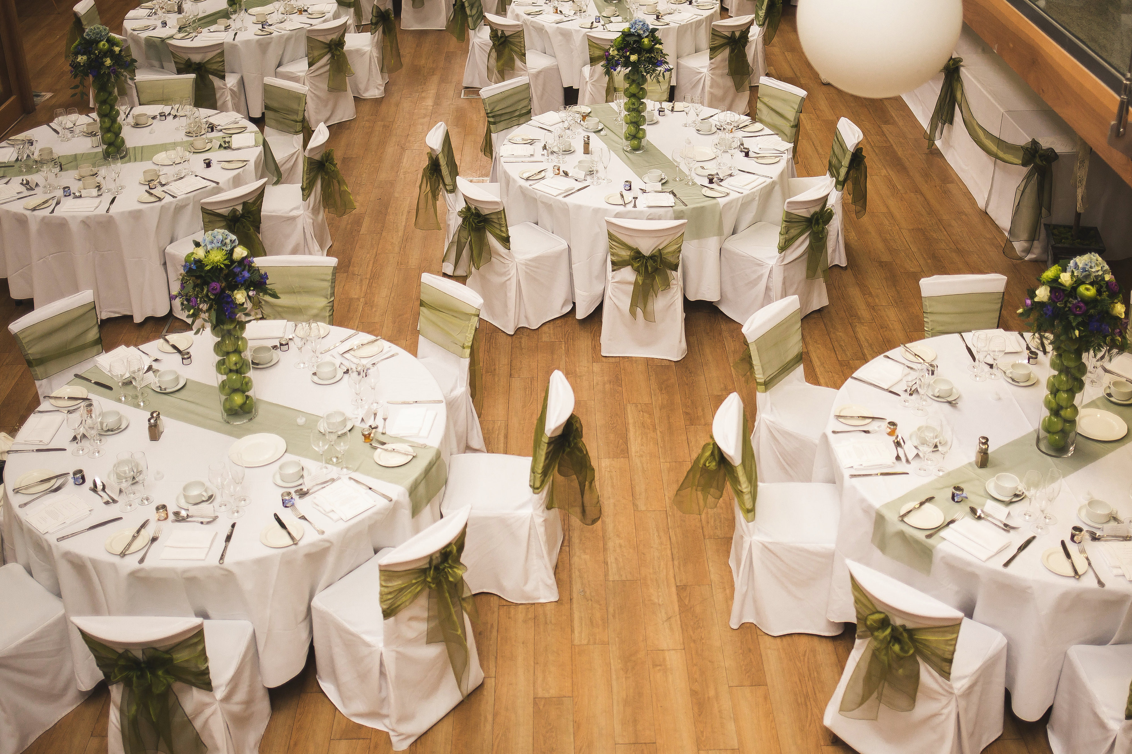 Elegant event space at Hatfield House with round tables and floral centerpieces.