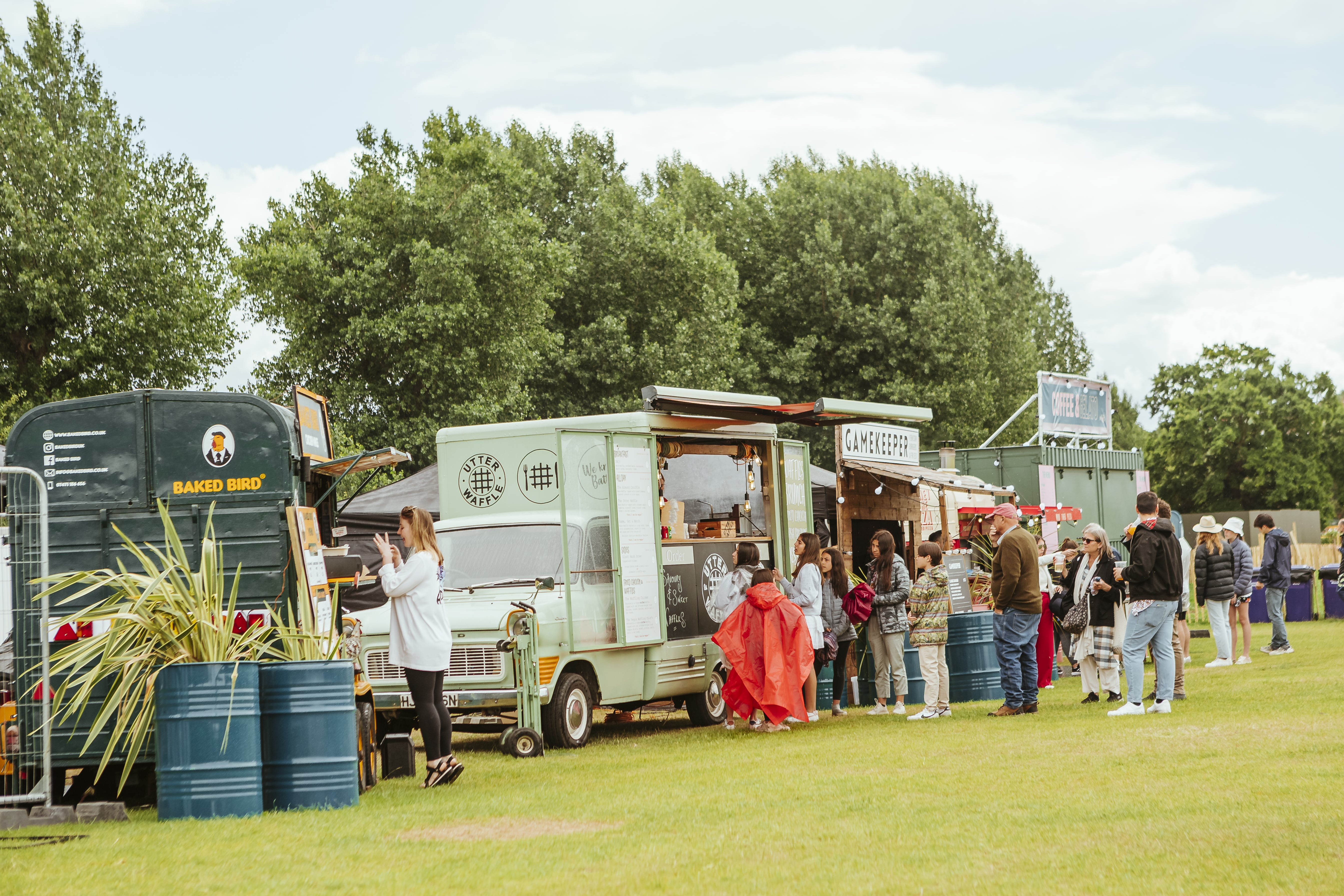 Outdoor food truck event at Hatfield House with lush greenery backdrop.