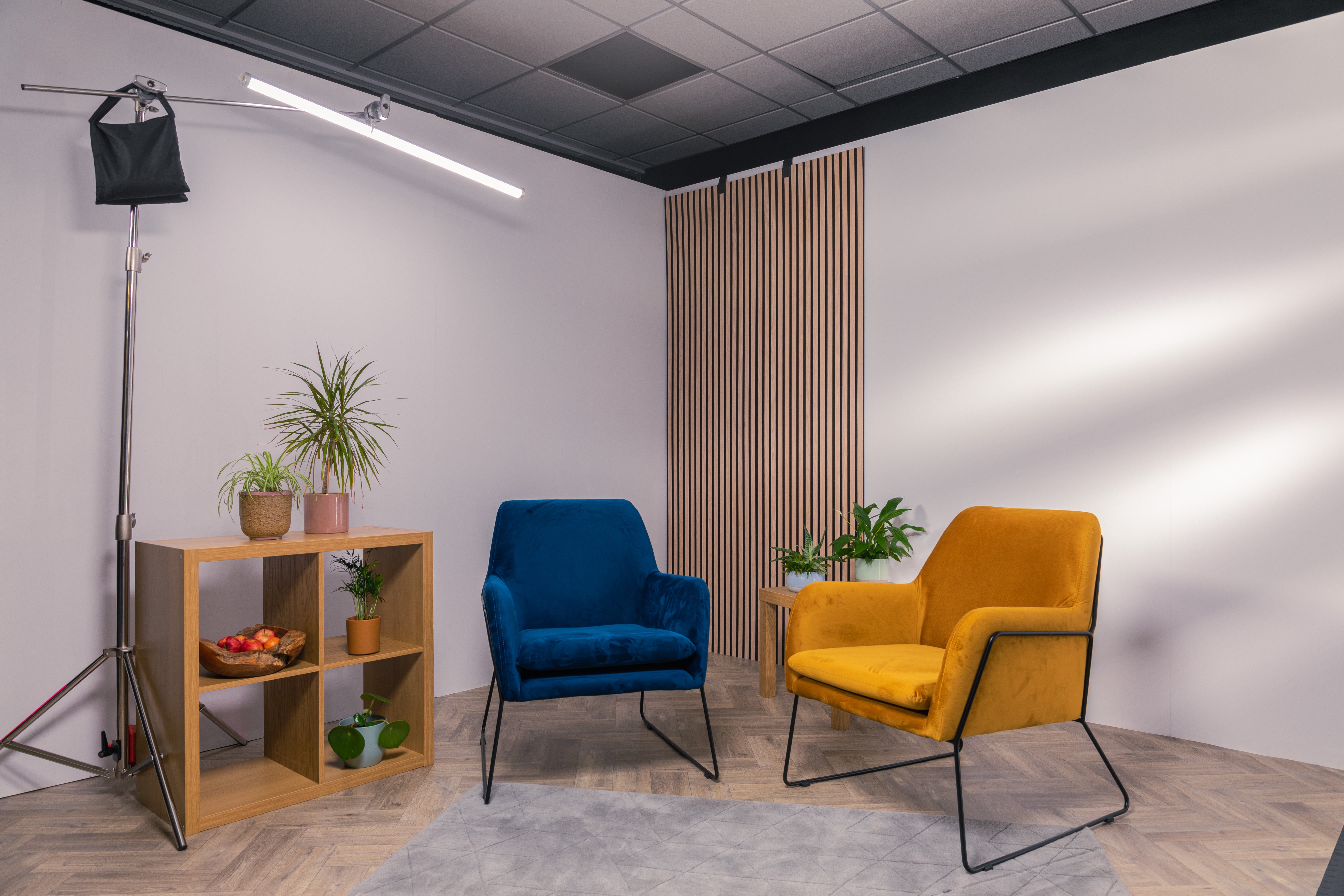 Modern meeting space with blue and yellow chairs for intimate discussions at Sound & Colour Films.