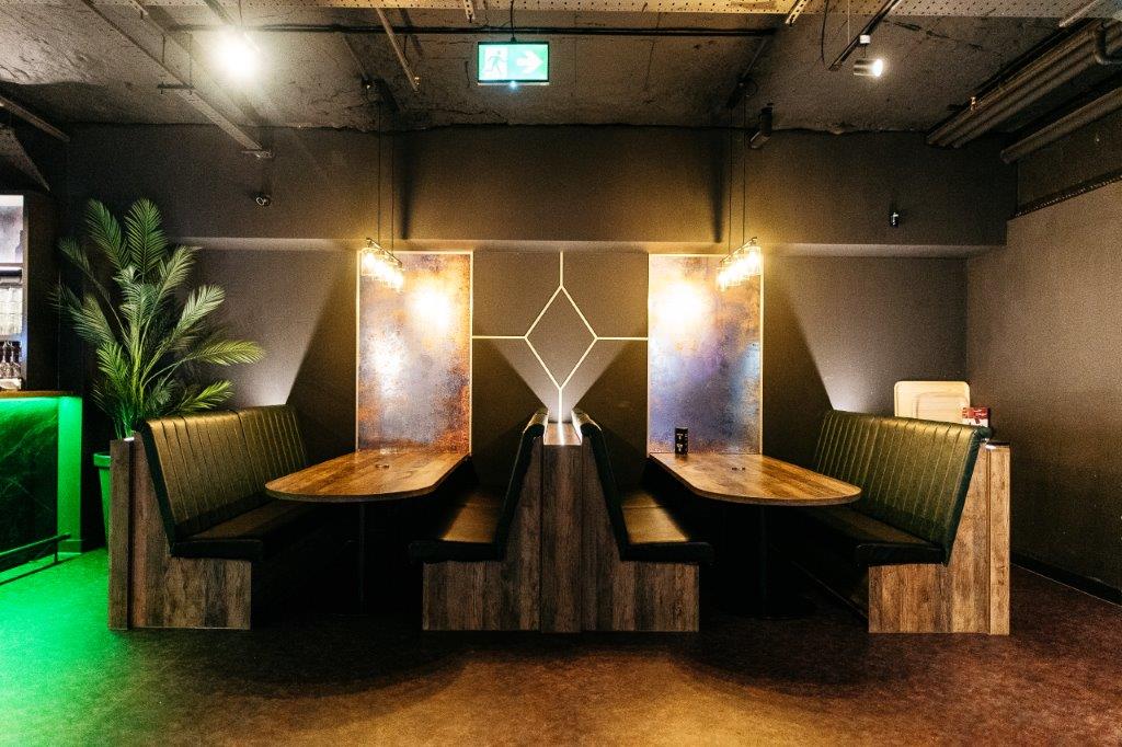 Modern meeting space with cozy booths, perfect for networking events in Cardiff.