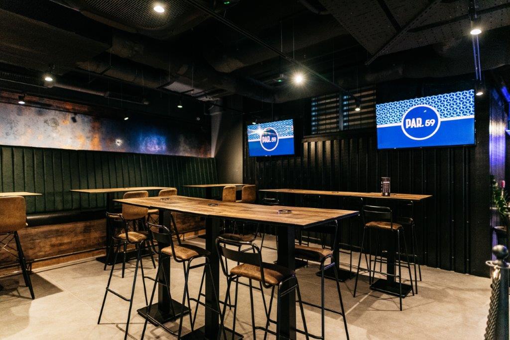 Modern event space in Par 59 Cardiff with high-top tables, ideal for networking and gatherings.