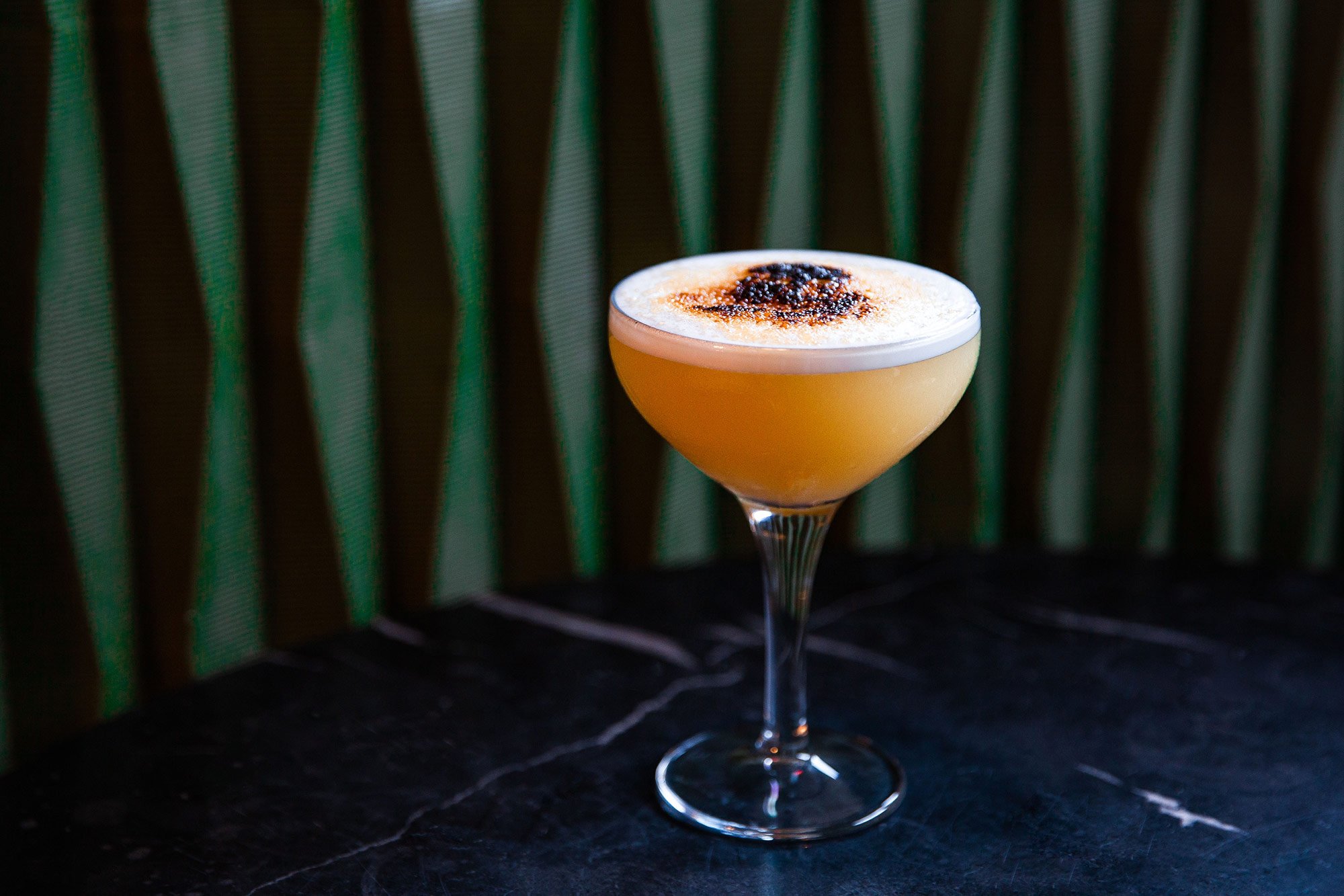 Elegant cocktail in a premium glass at The Clubhouse, perfect for networking events.