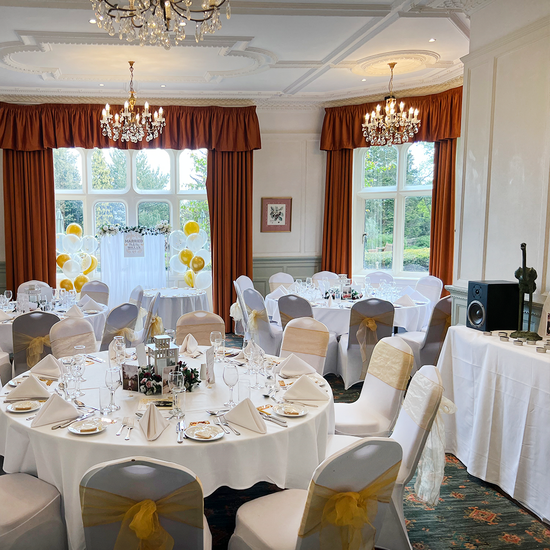 Elegant wedding venue at Warren House Hotel with round tables and gold accents.